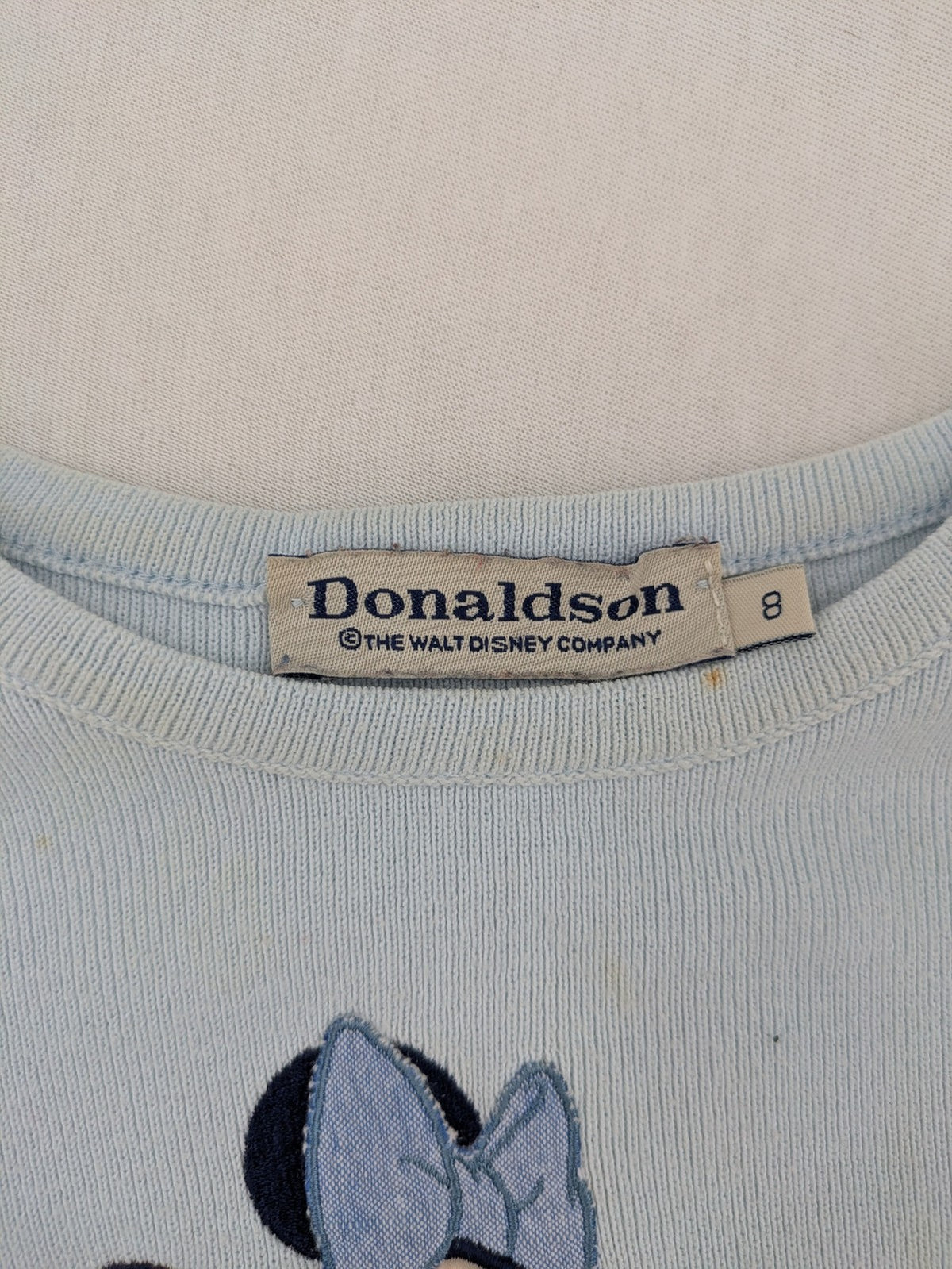 Donaldson multi turtle neck jumper light blue with embroidered Minnie Mouse graphic and ribbed texture.
