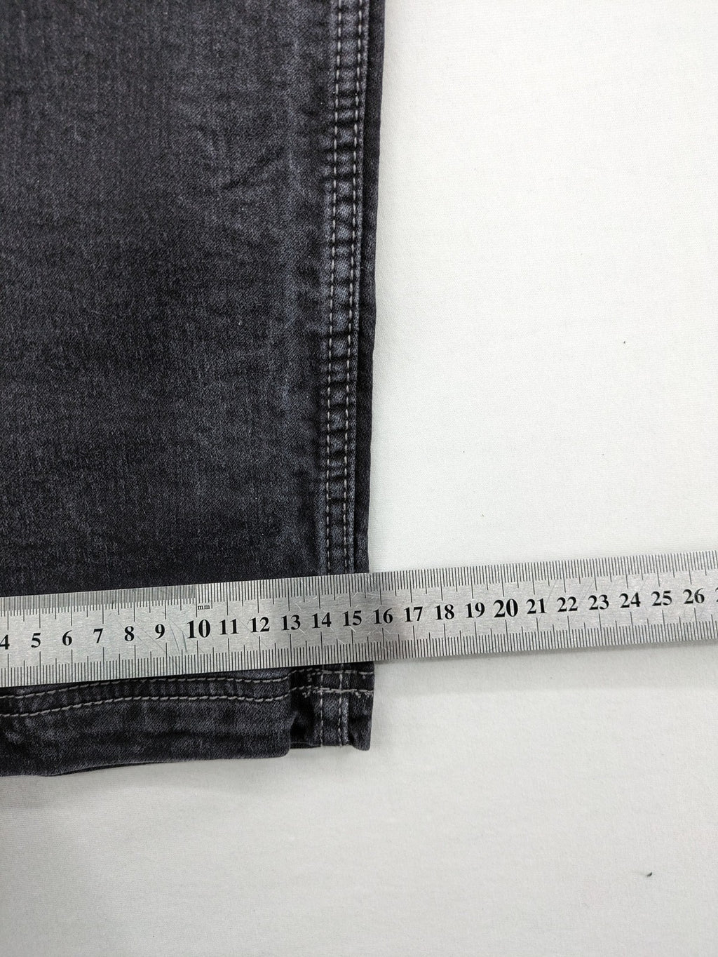 Tom Tompson grey slim tapered jeans with washed denim finish and subtle branding.