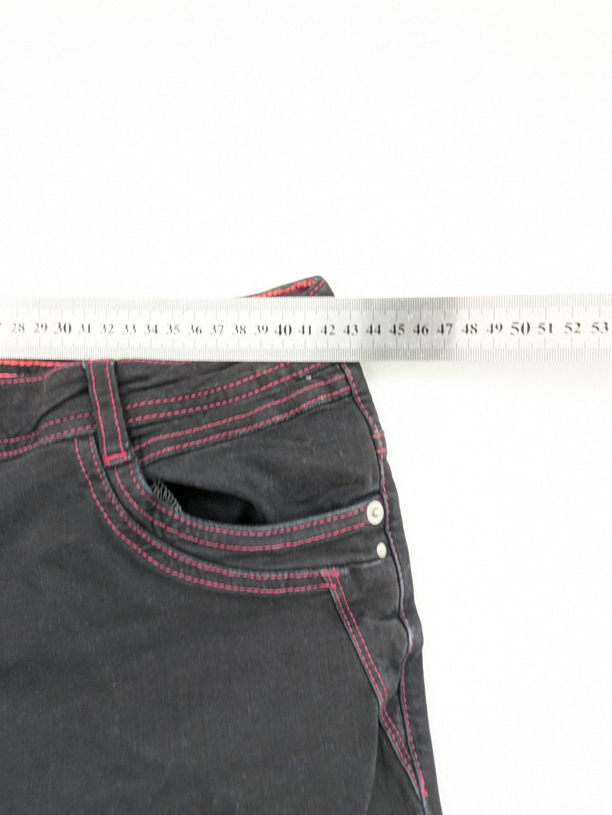 Denim black straight jeans with pink contrast stitching and classic 5-pocket style.