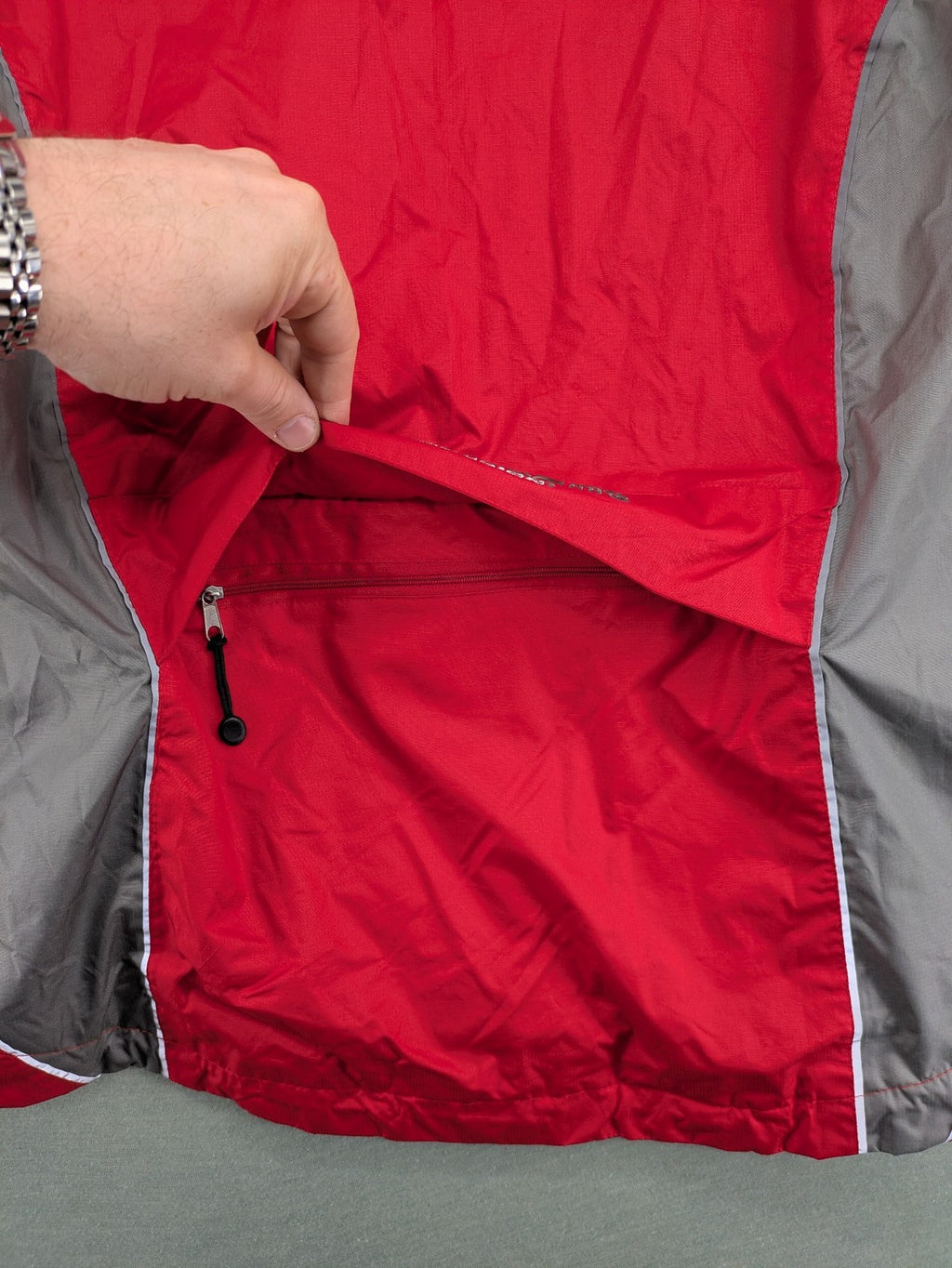 Movement Session grey and red windbreaker jacket with colorblock pattern and full zip.