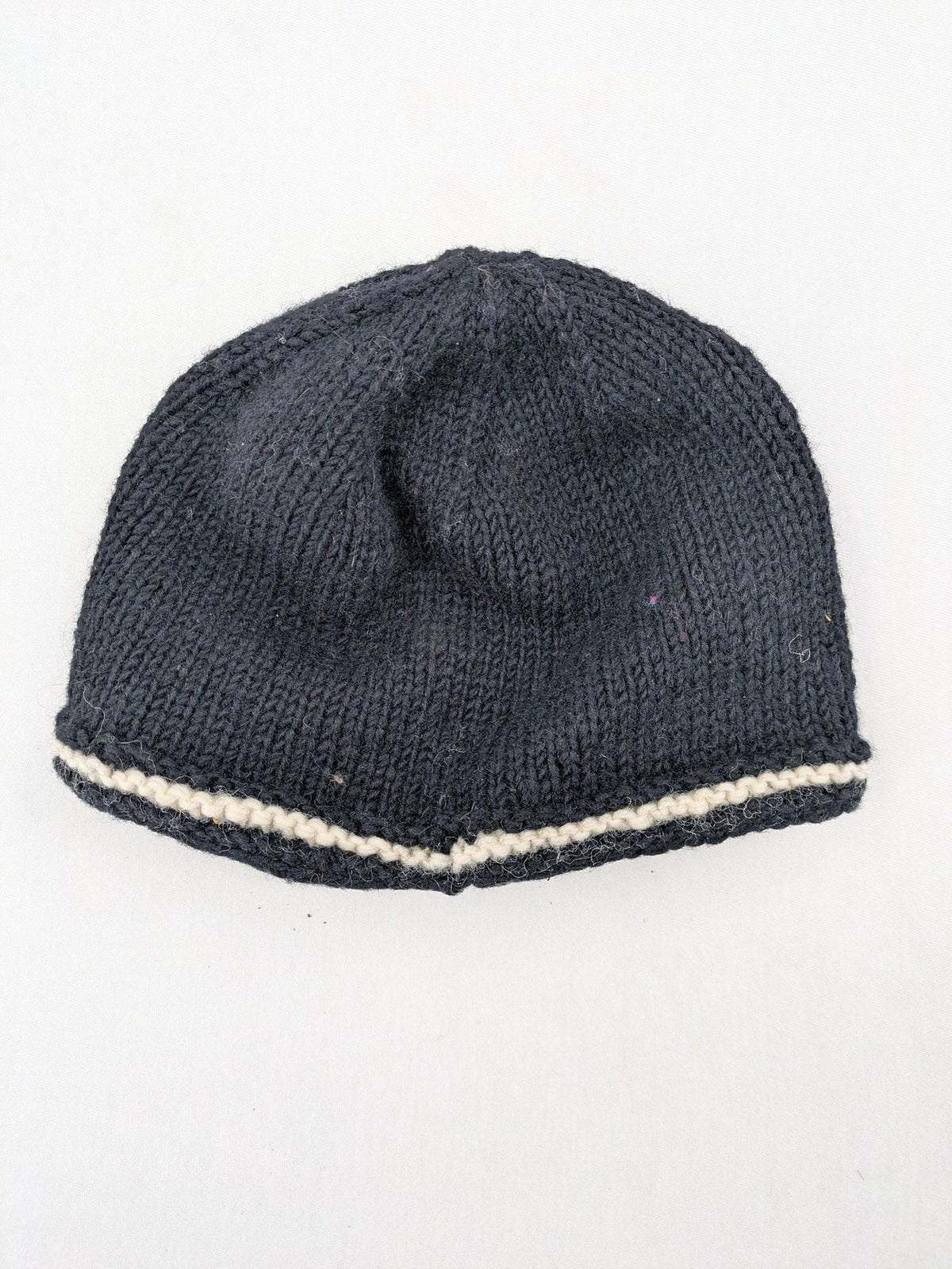 Fischers Textil multi beanie hand-knitted wool with fleece lining and floral appliqué.