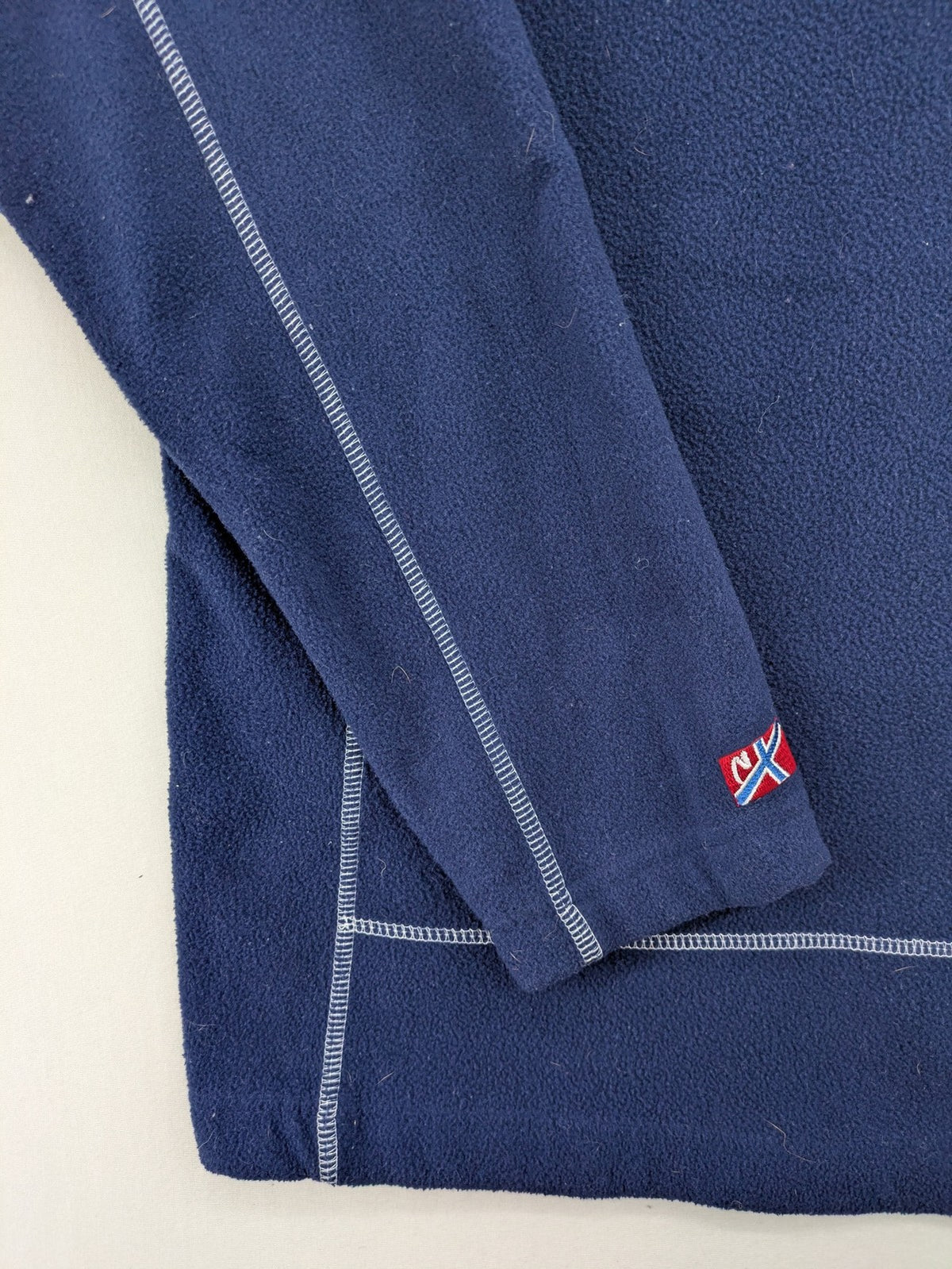 Nebulus navy turtle neck jumper with graphic print collar and "Himalaya Expedition" patch.