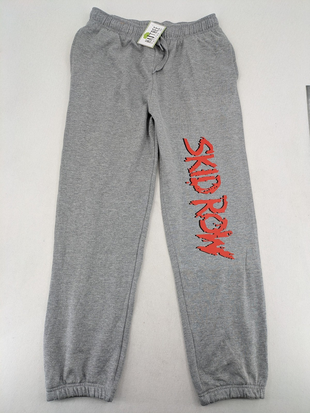 Skid Row grey joggers with red band logo, soft cotton blend, elastic waistband.