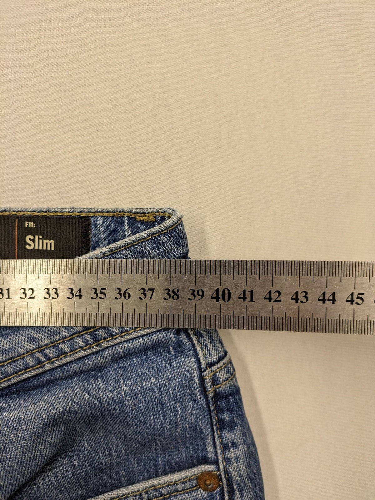 CHASIN' blue slim fit jeans with button fly and classic denim craftsmanship.