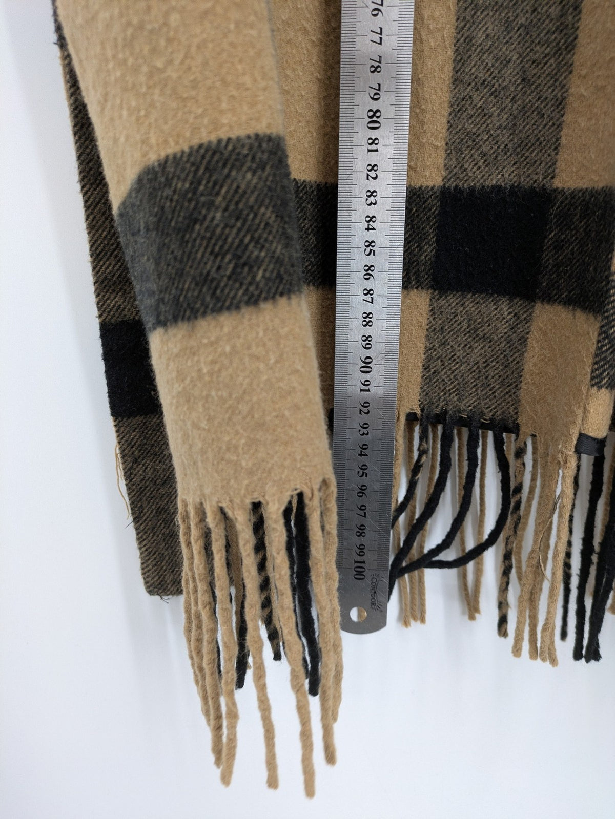 Reserved cream coat with brown and black check pattern, fringe hem, wool blend material.
