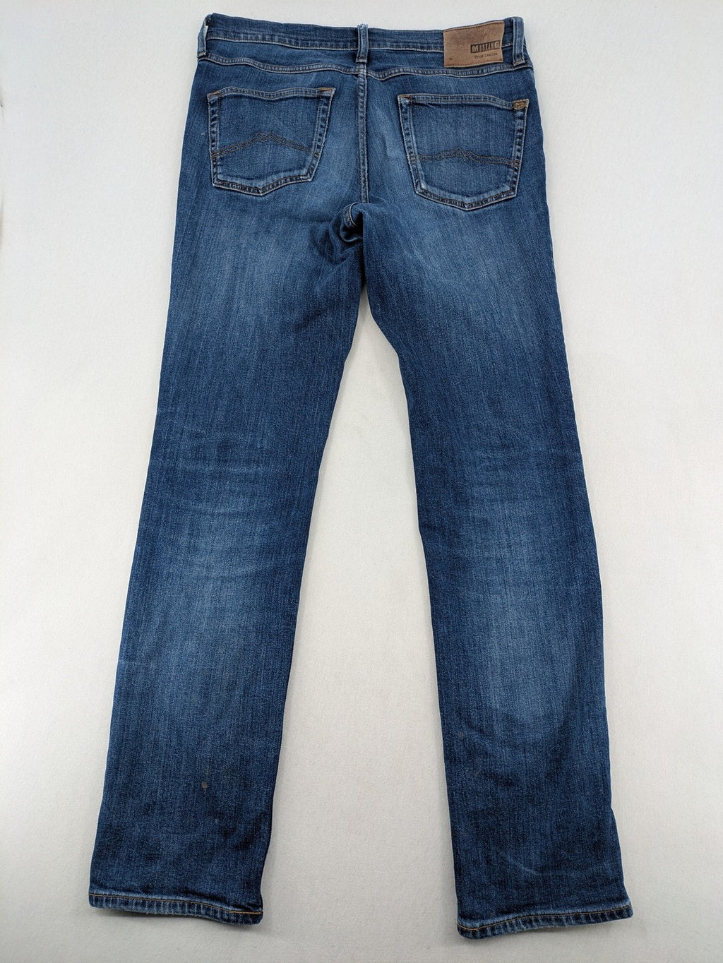 Mustang blue tapered jeans with slim fit, medium rise, and classic denim texture.