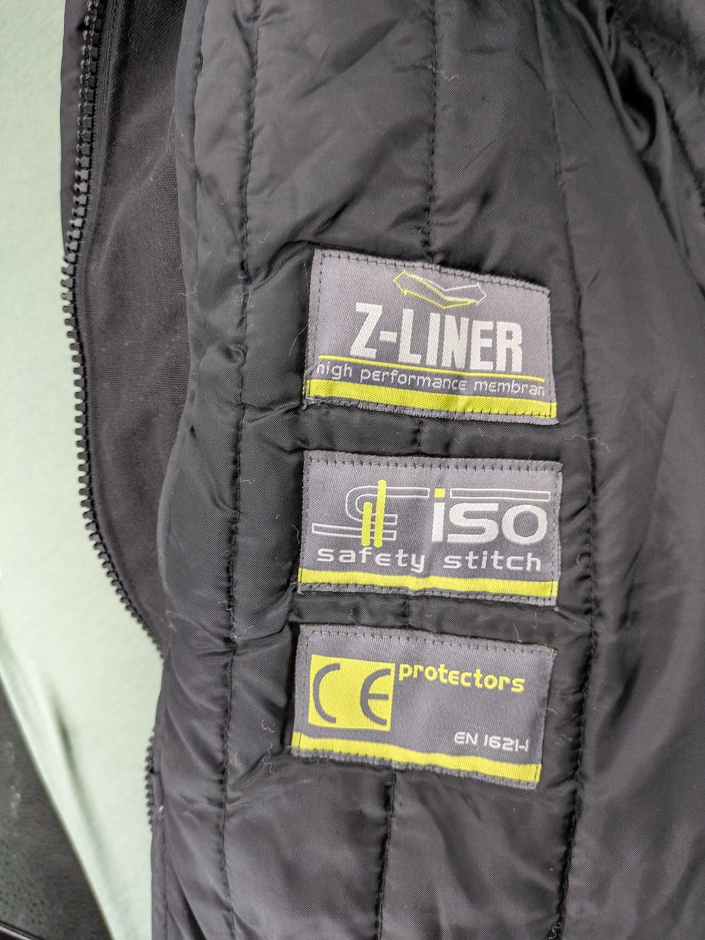 Advanced Experience black motorcycle jacket with Z-Liner membrane and CE protectors, durable Cordura material.