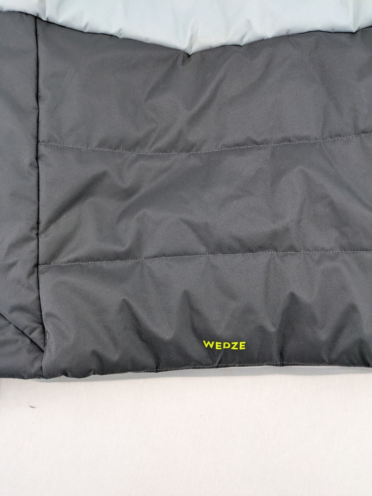 Wedze ski coat grey and black colorblock design with neon accents and fleece lining.