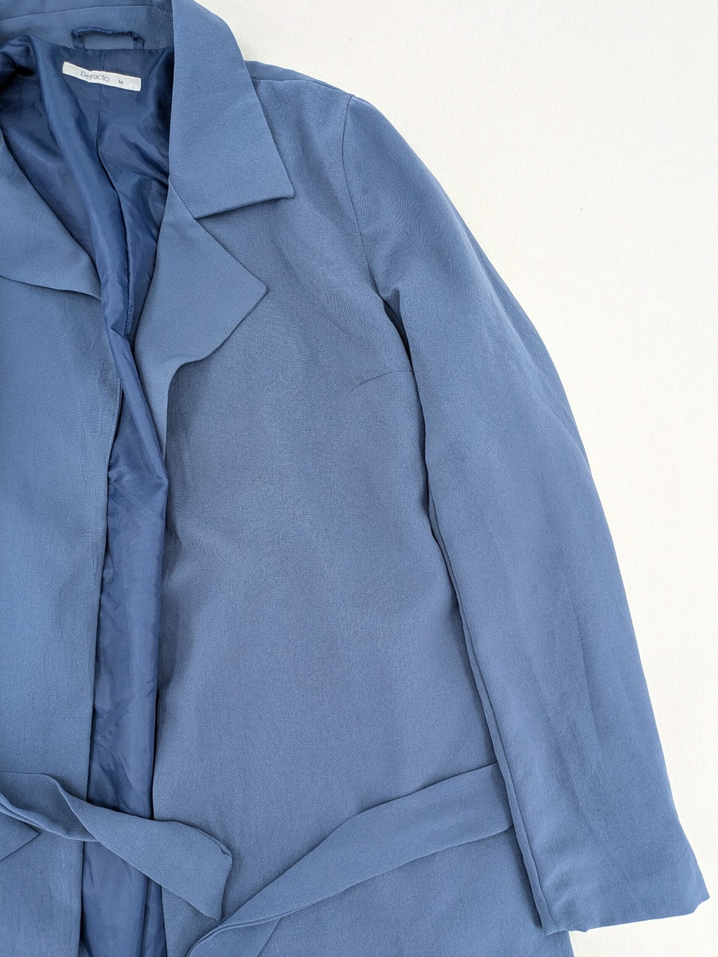DeFacto blue trench coat with classic lapels and matching self-tie belt.