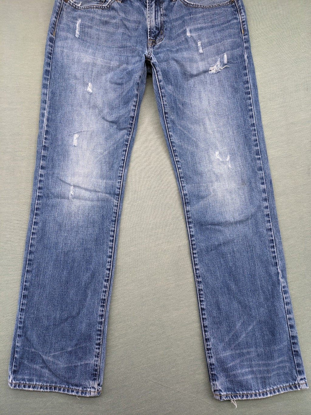 American Eagle Outfitters blue straight jeans with distressed detailing and classic five-pocket design.