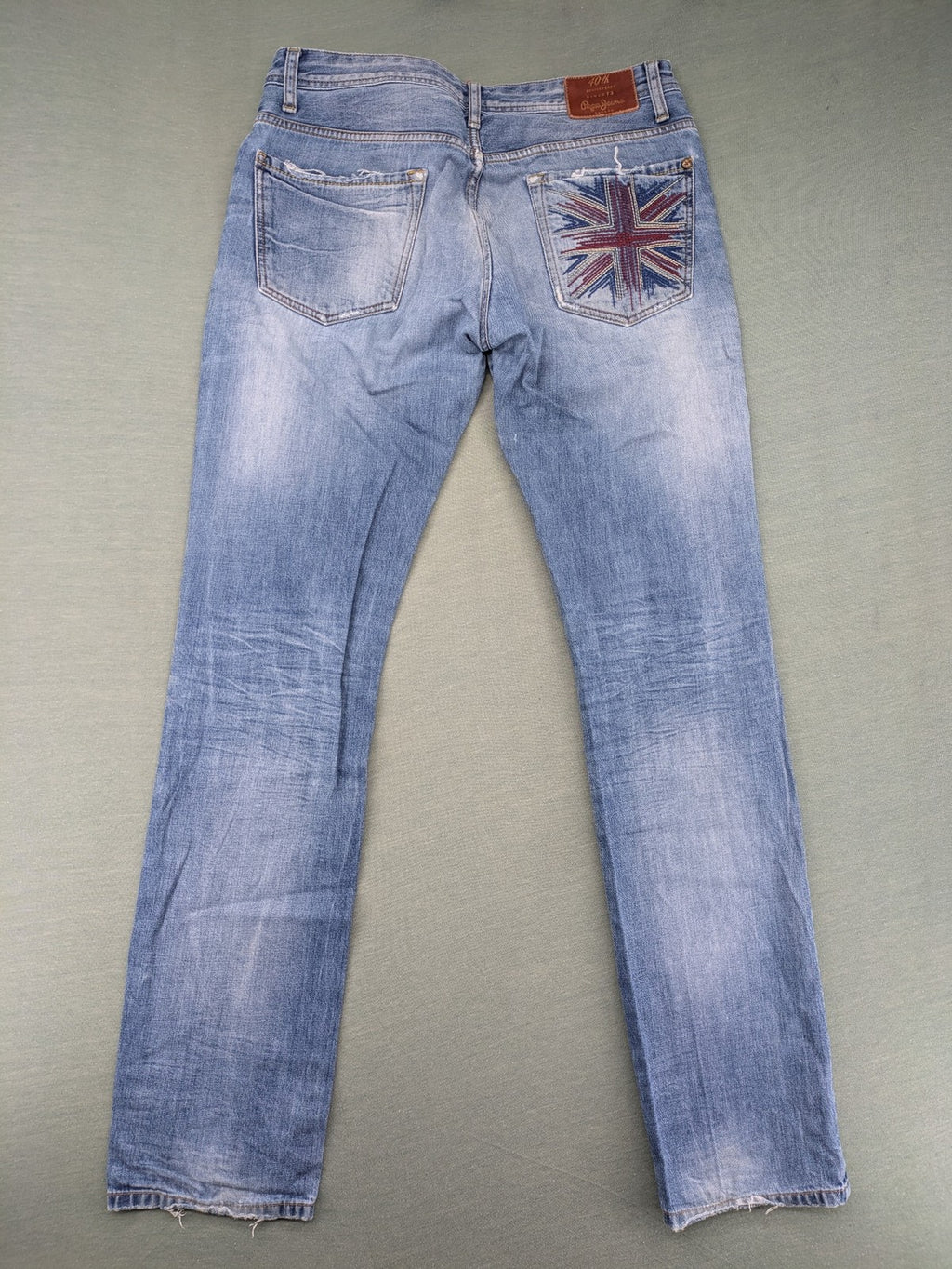 Pepe Jeans blue straight jeans with Union Jack embroidery and distressed denim finish.