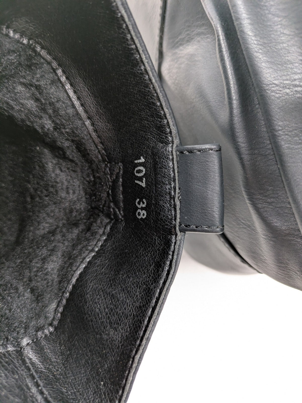 DAF black booties with decorative strap and studded details, made of faux leather.