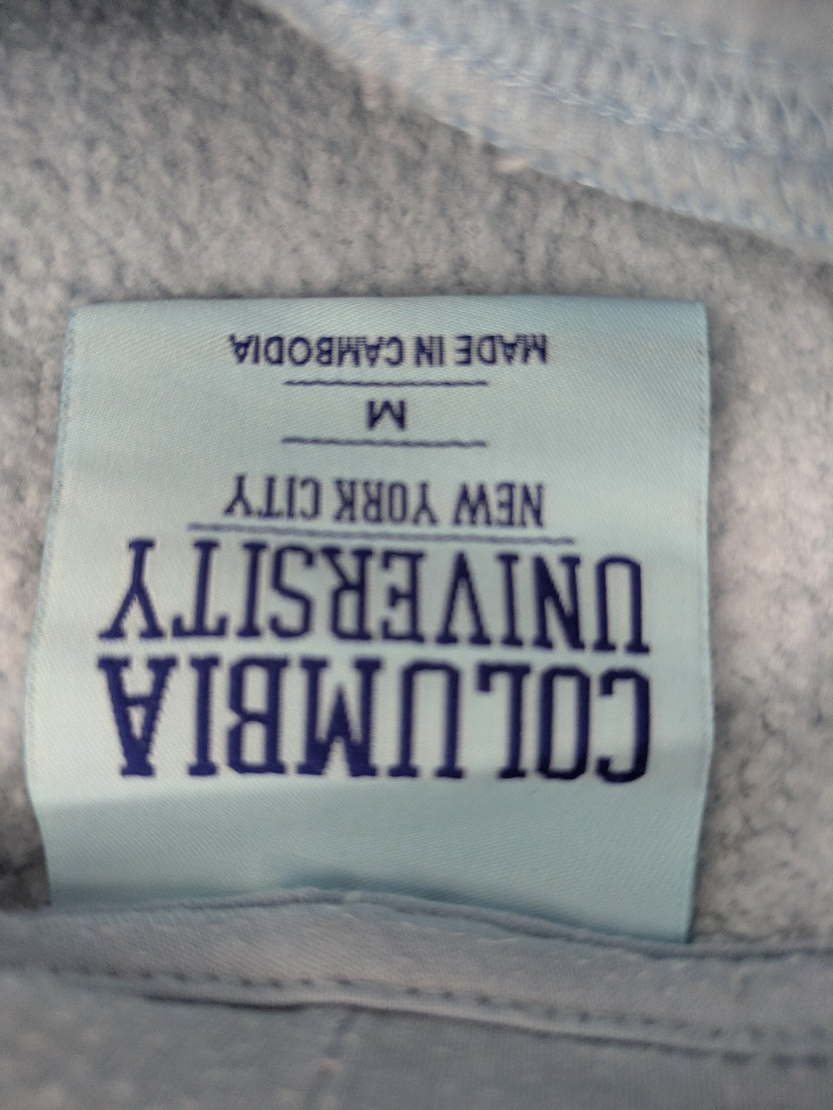 Columbia University blue hoodie with large "Columbia University" text on chest.