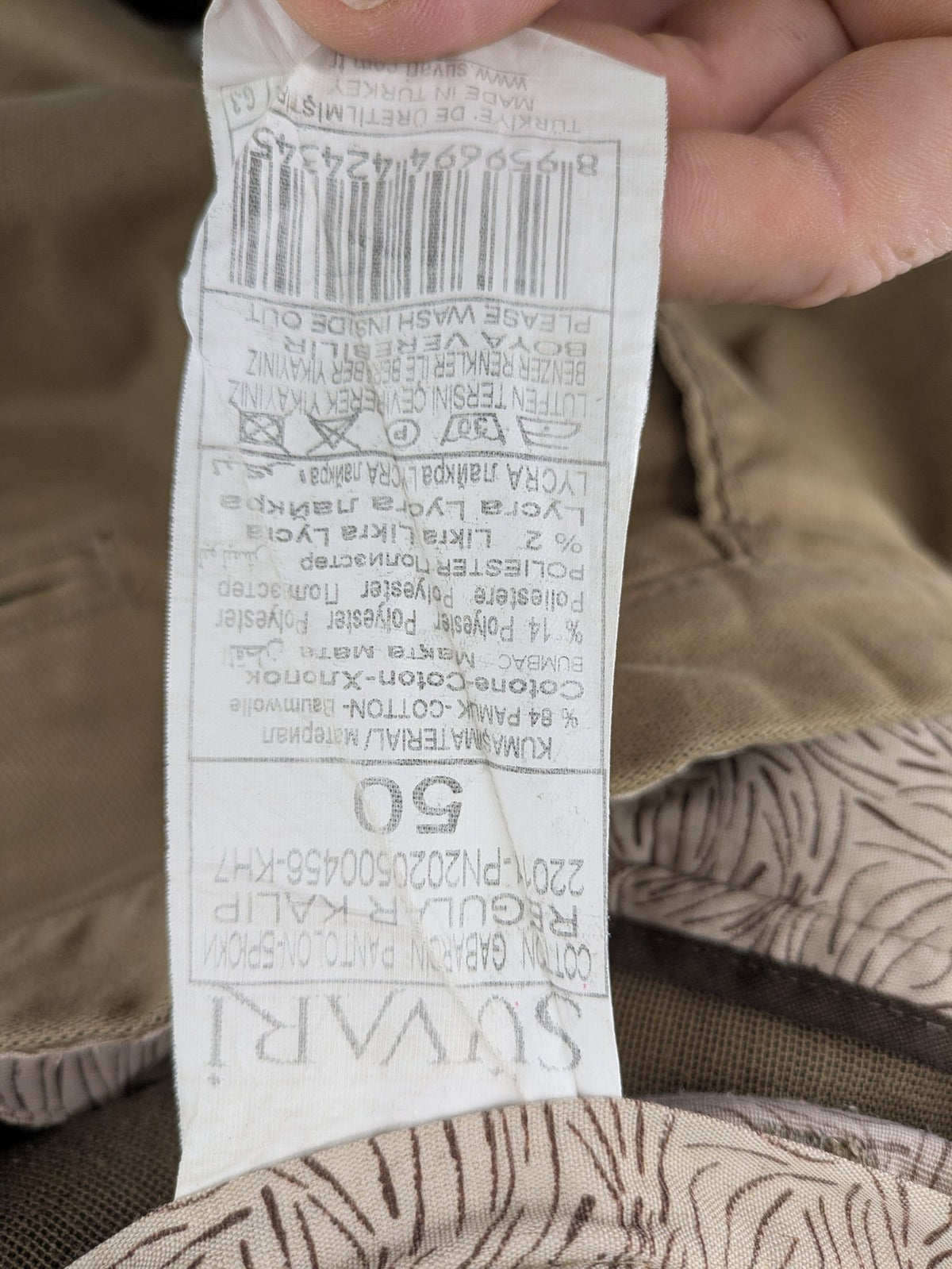 Süvari khaki chino pants flat-front design with patterned waistband detail, cotton blend material.