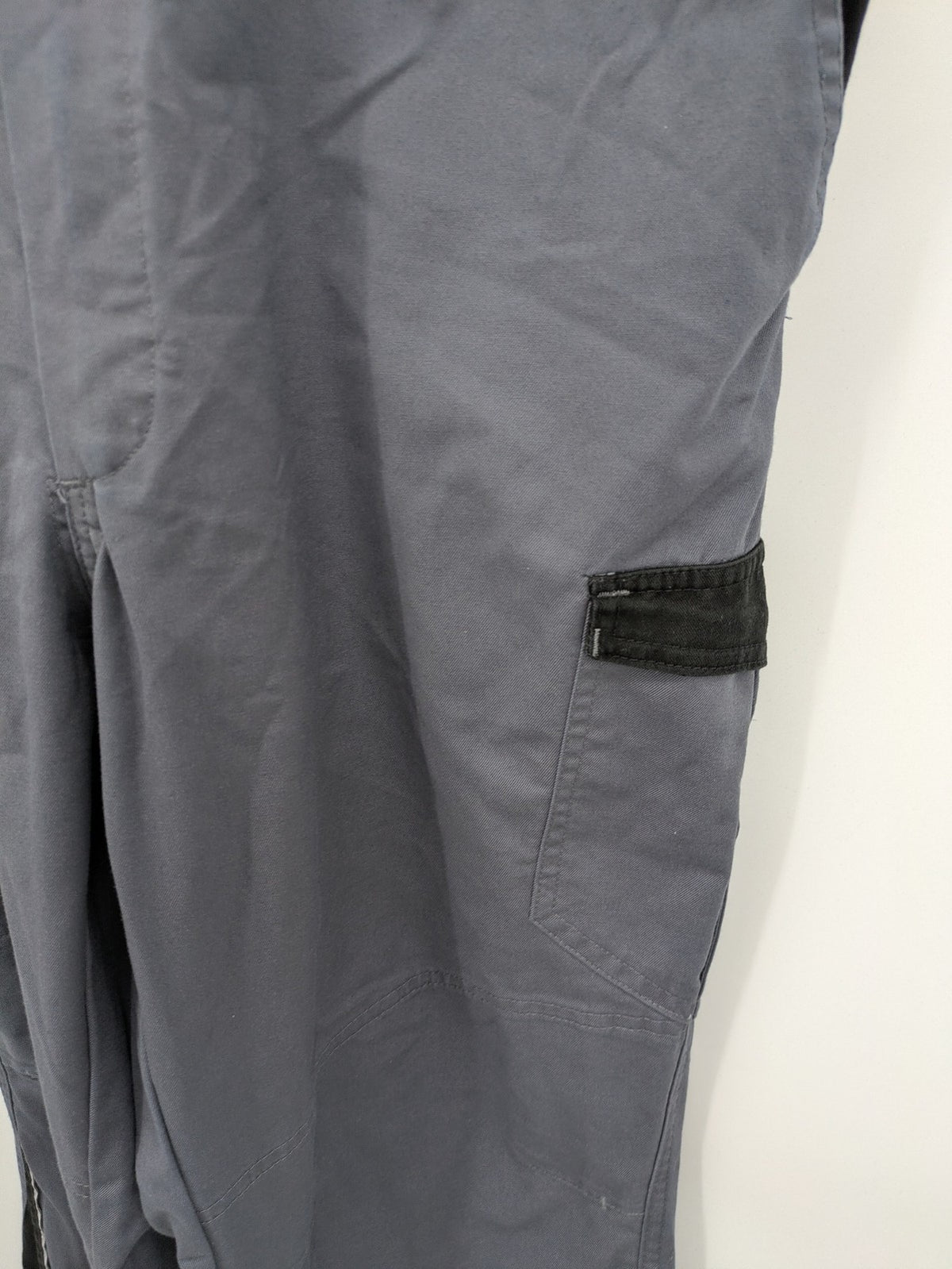 Works Wear grey and black overalls with adjustable straps and multiple pockets.