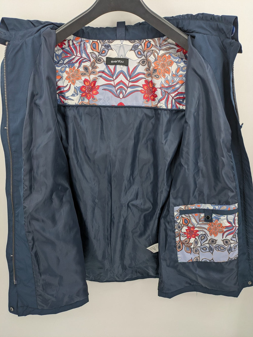 everYou navy parka jacket with hood, adjustable drawstring, patterned lining, button closure.