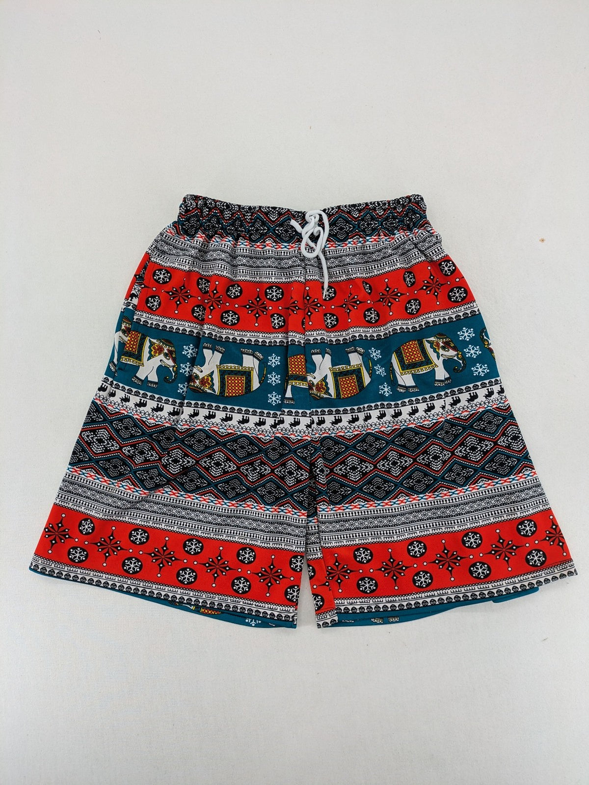 Elefanten multi shorts featuring vibrant elephant and geometric patterns with elastic waistband.
