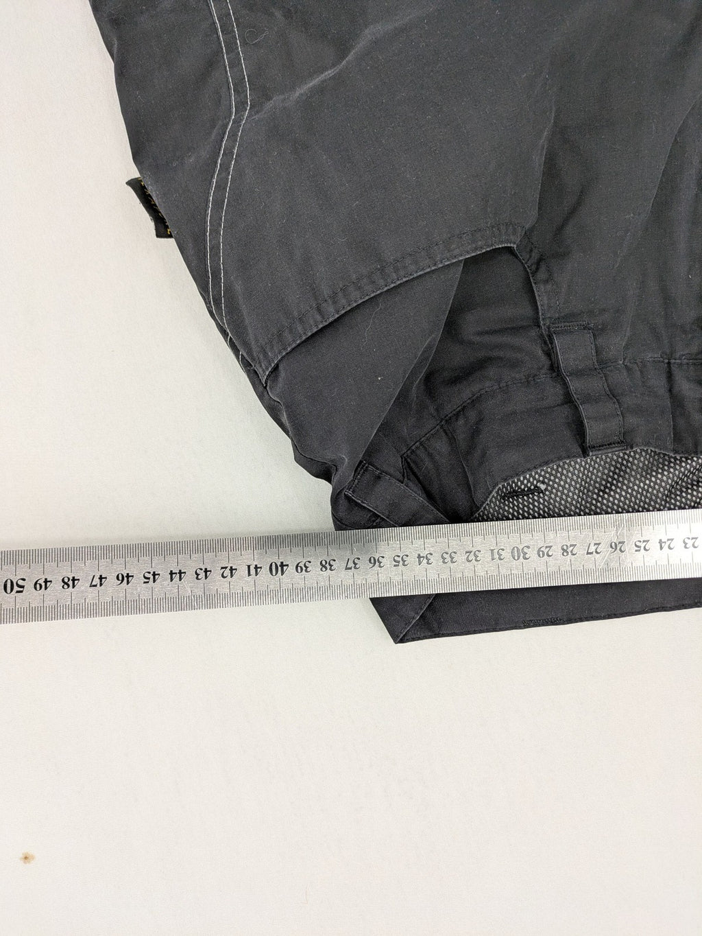 Jack Wolfskin grey outdoor pants with embroidered logo and side zip pocket.