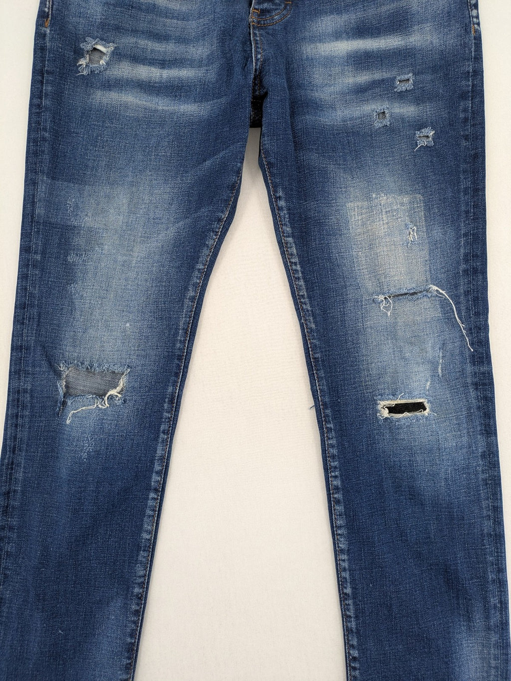 ICON 2 blue slim fit jeans distressed stretch denim with button fly and faded details.