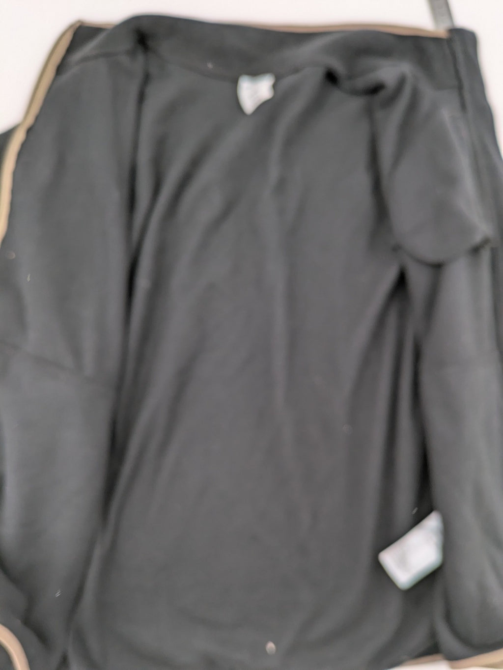Crane beige and black fleece jacket full zip with cream accents and zippered pockets.