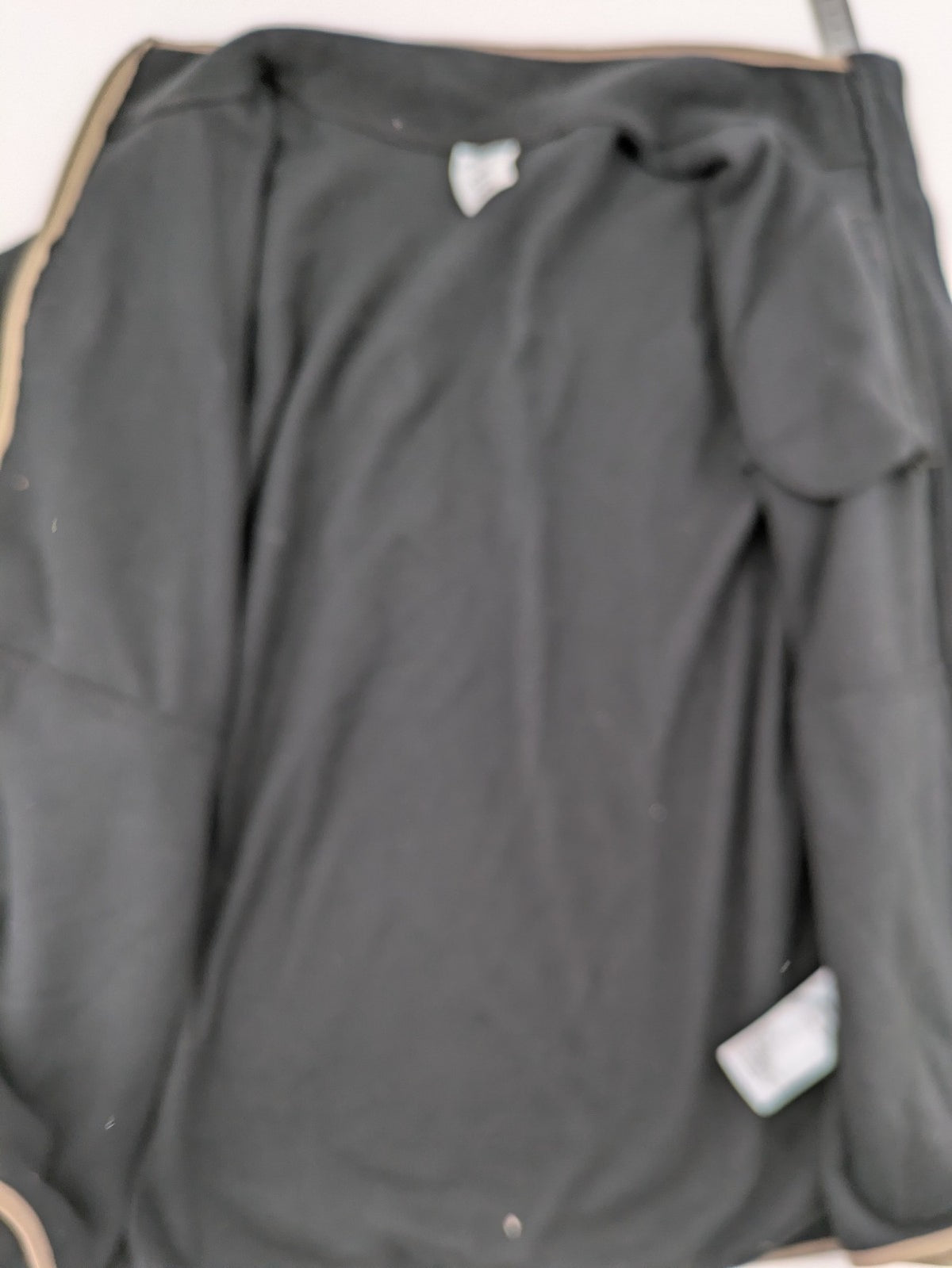Crane beige and black fleece jacket full zip with cream accents and zippered pockets.