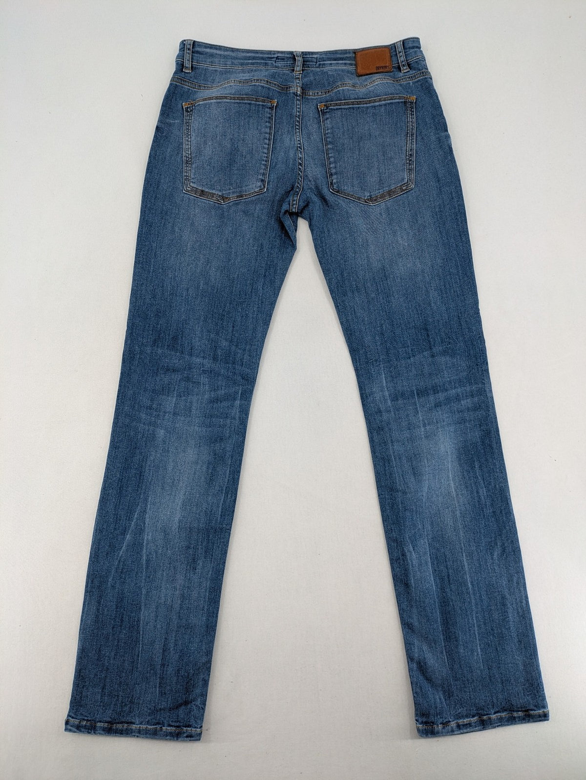 Drykorn blue straight jeans with stretch denim, classic fit, and logo patch on waistband.