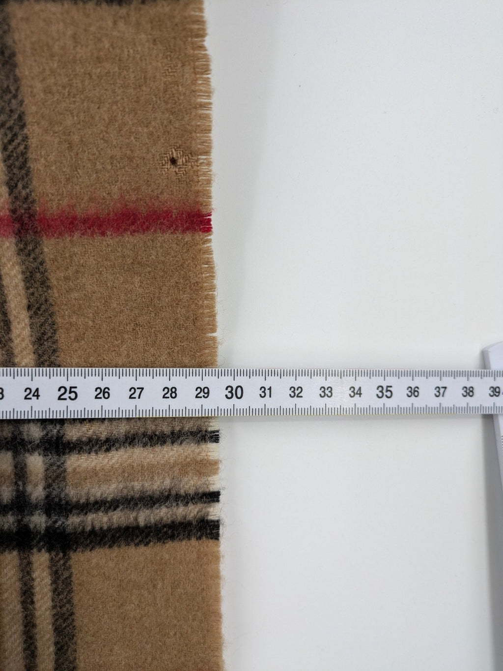 Karo unisex scarf camel brown tartan pattern 100% cashmere with black, white, and red accents.