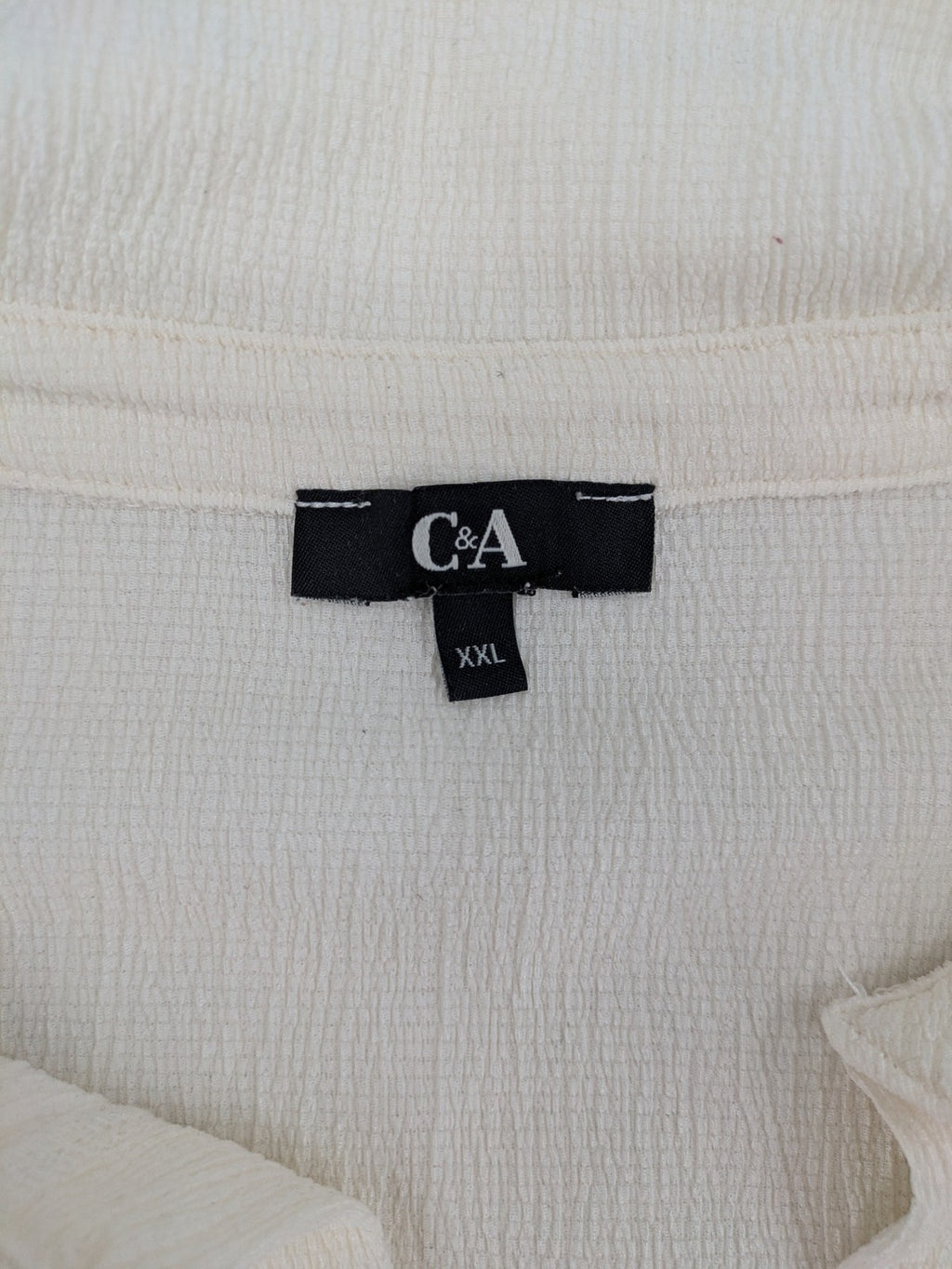 C&A cream blouse XXL textured crinkle fabric with gold button placket and wavy hem.