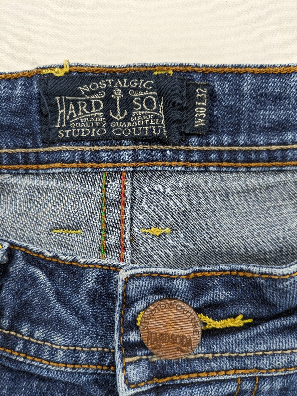 Soda blue straight jeans with distressed rips and button fly, cotton blend material.