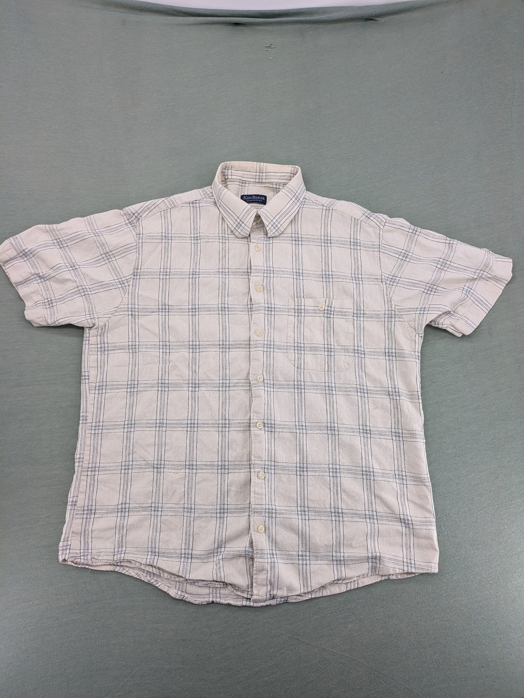 Ken Baker short-sleeve button-down shirt beige blue check pattern with single chest pocket.