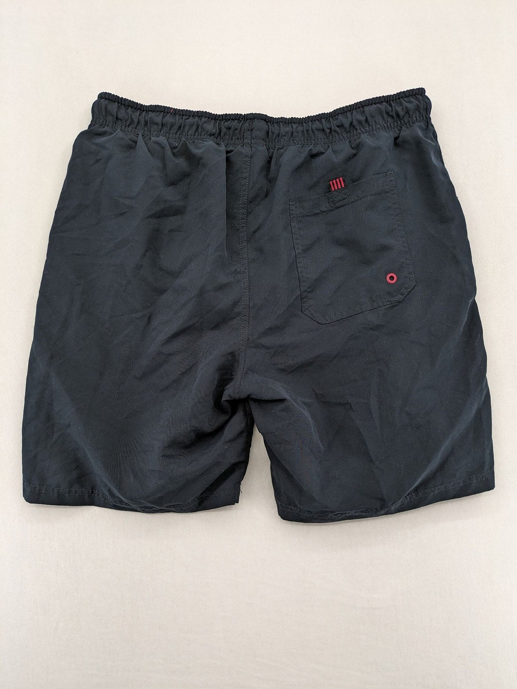 LC Waikiki navy swim shorts with red accents, elastic waistband, and quick-dry material.