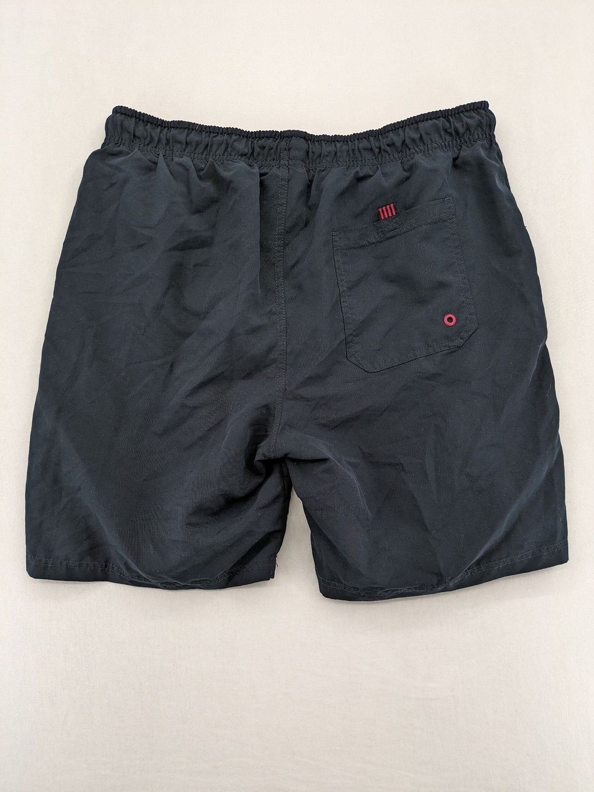 LC Waikiki navy swim shorts with red accents, elastic waistband, and quick-dry material.