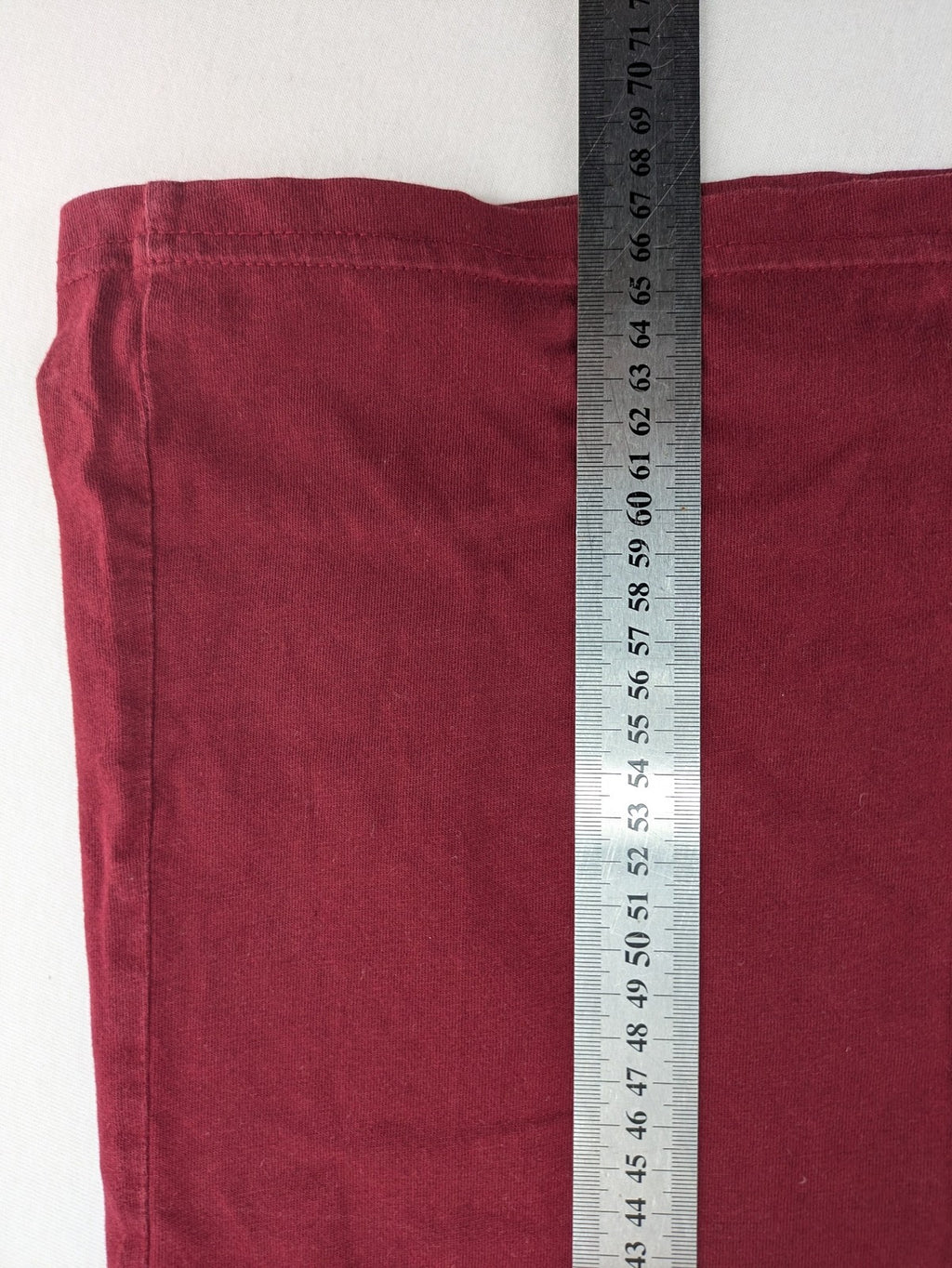 Carhartt burgundy tank top 100% cotton with iconic logo patch at hem.
