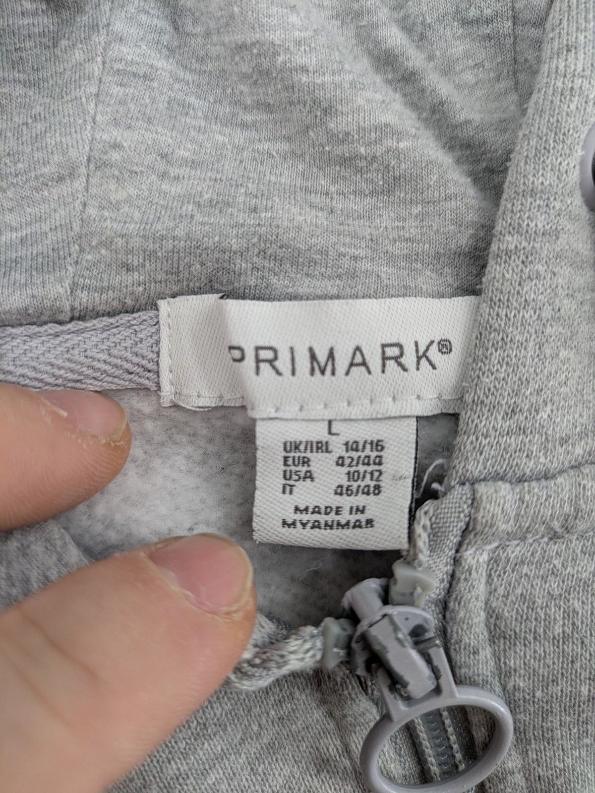 Primark grey zip-through hoodie featuring yellow Smiley logo and Nevermind graphic.