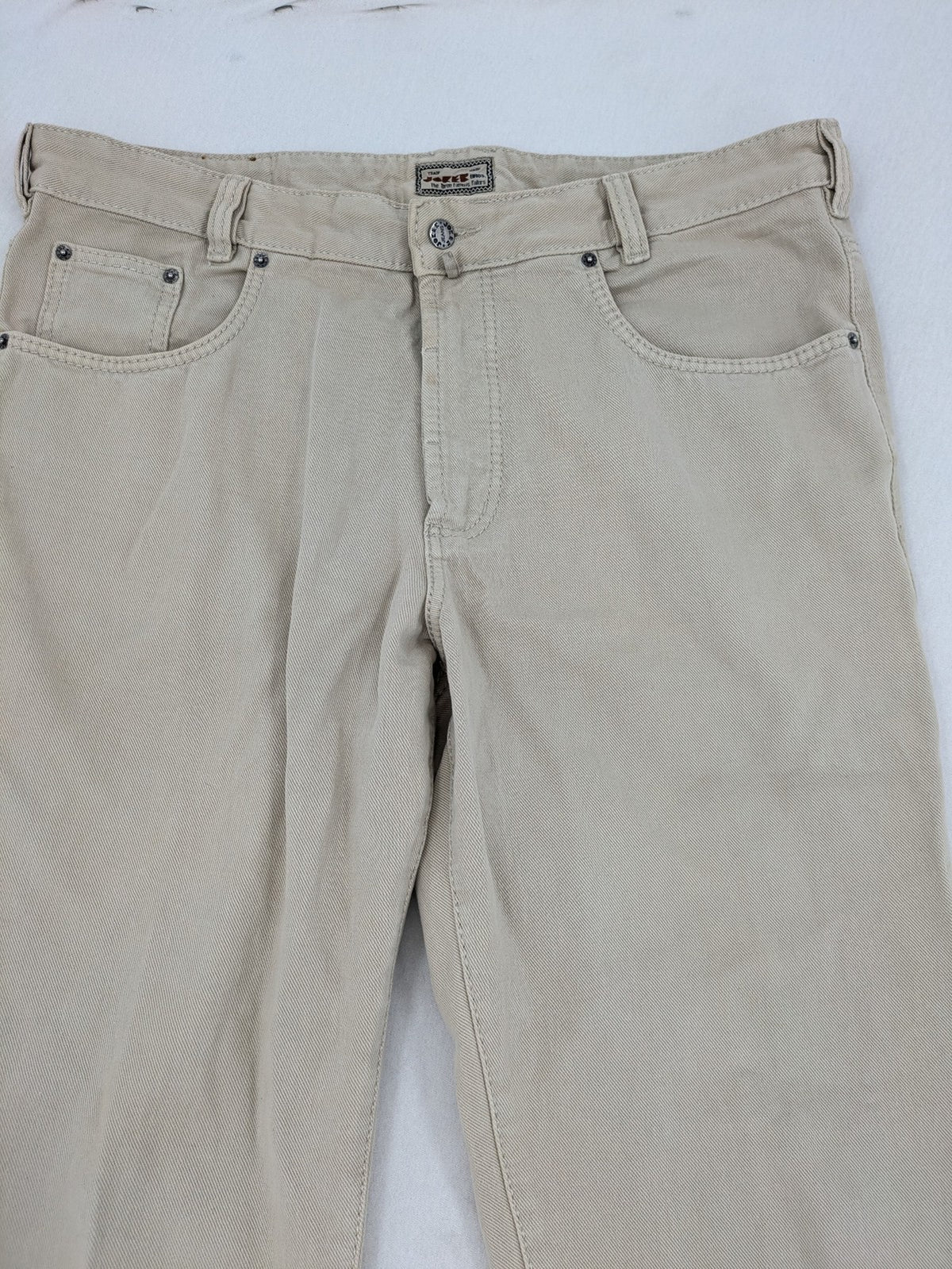 Joker beige straight jeans 5-pocket design with zipper and button closure.