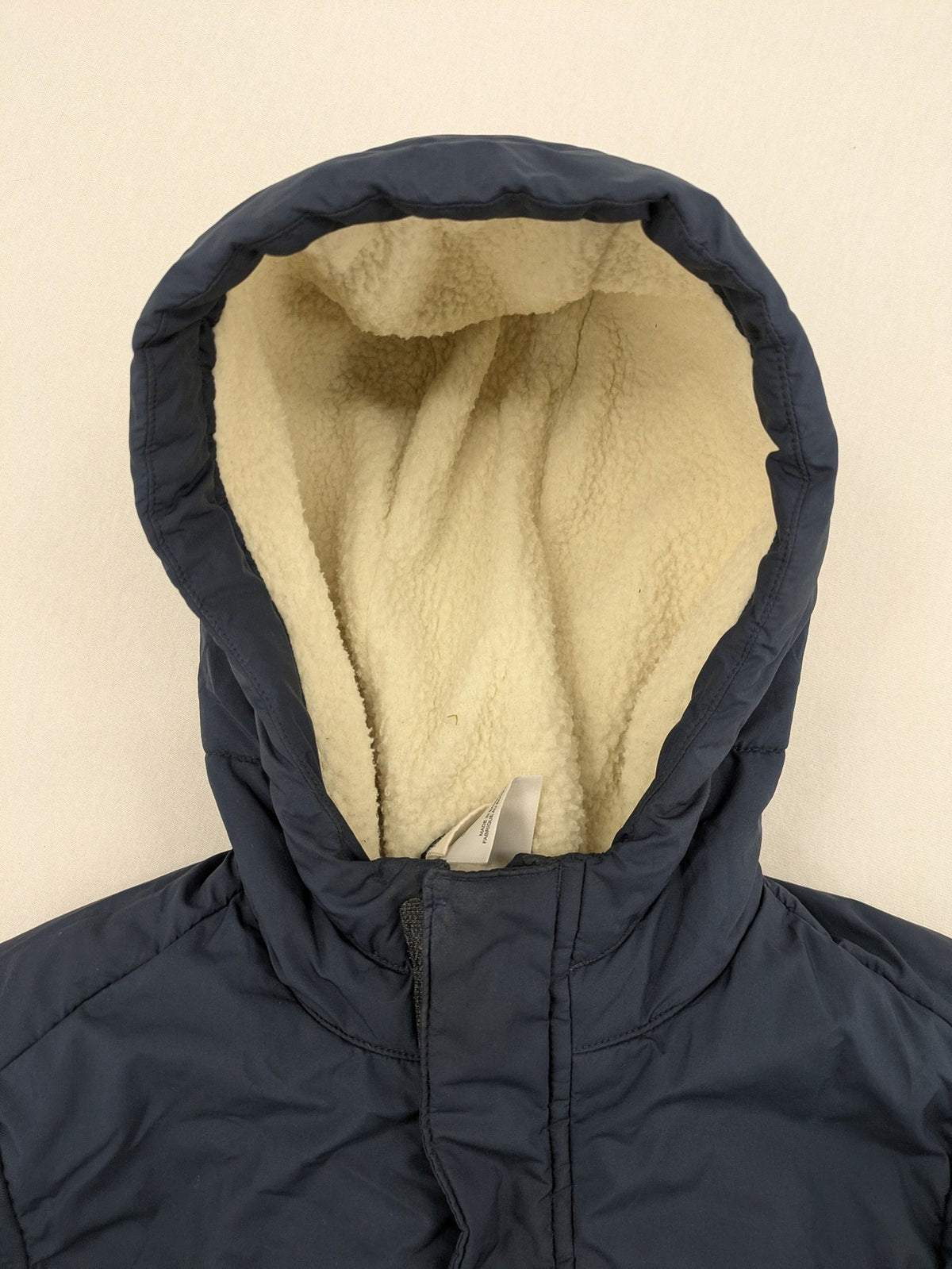 Jack Wolfskin cream and navy puffer coat with quilted design and Sherpa fleece lining.