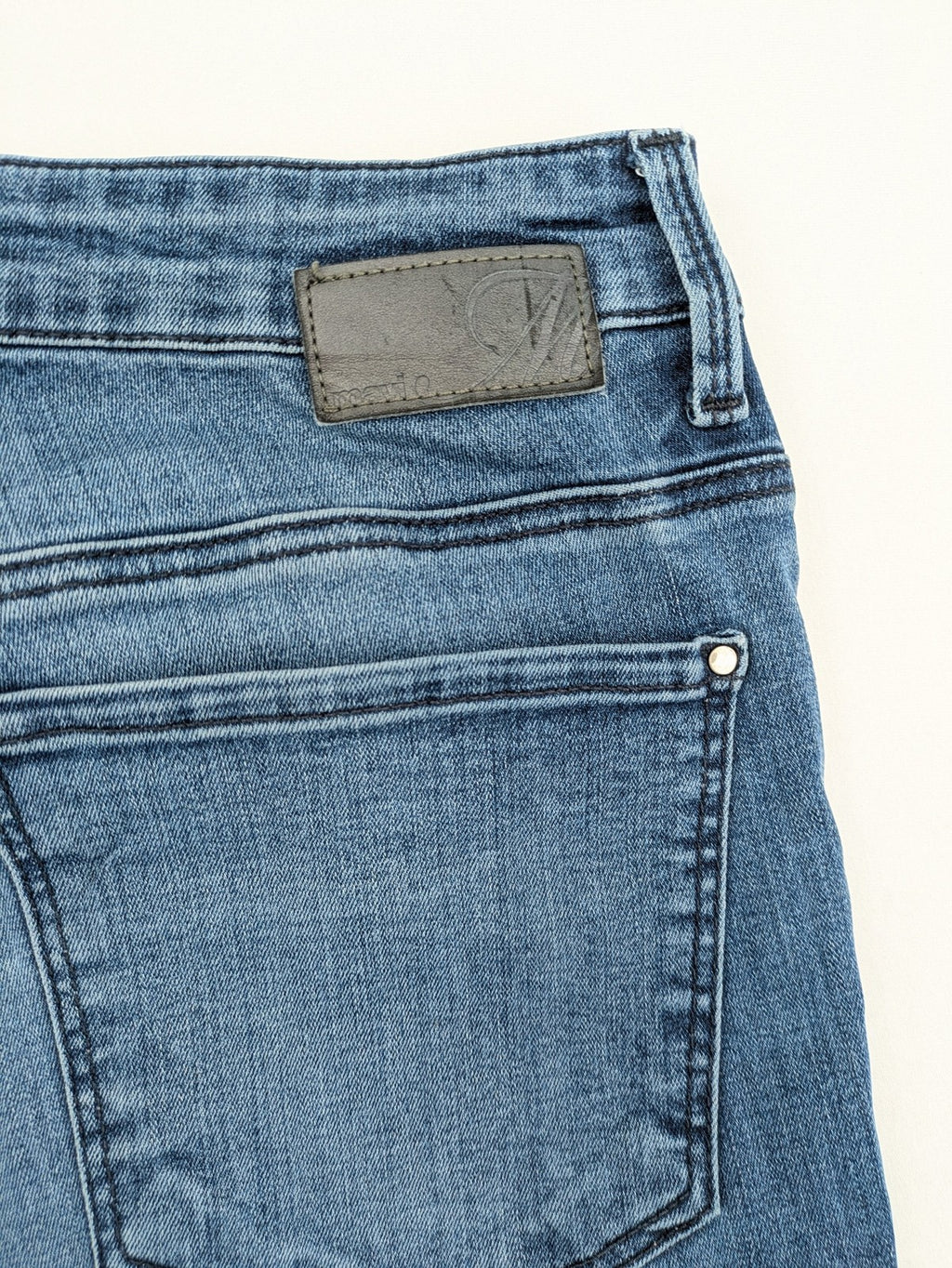 Mavi blue high rise super skinny jeans with medium wash and stretch denim material.