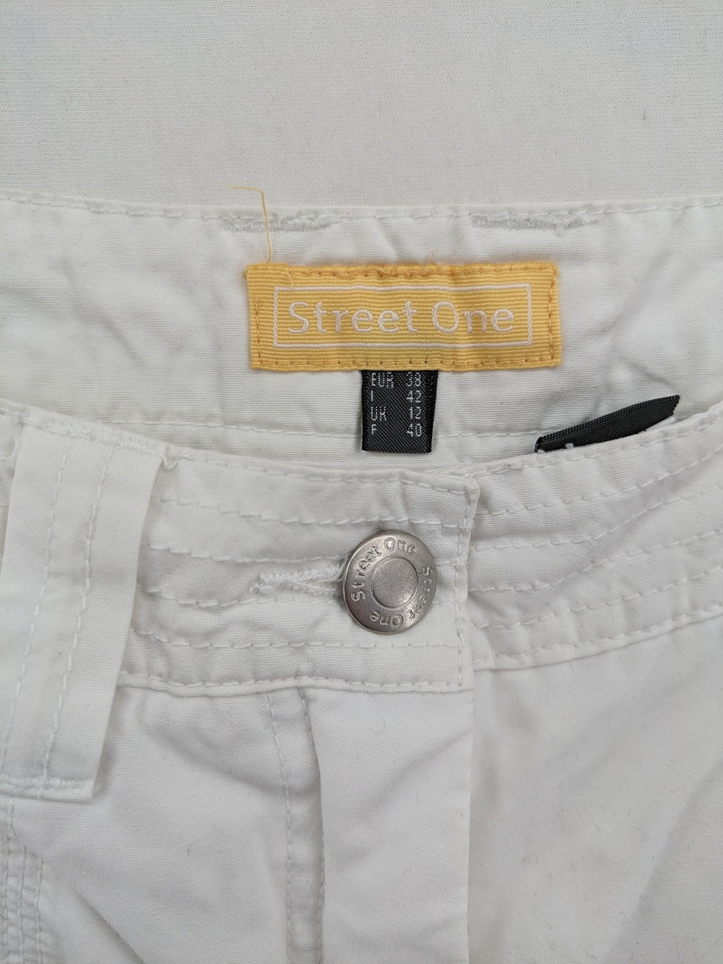 Street One white cargo pants with side pockets and wide leg design.