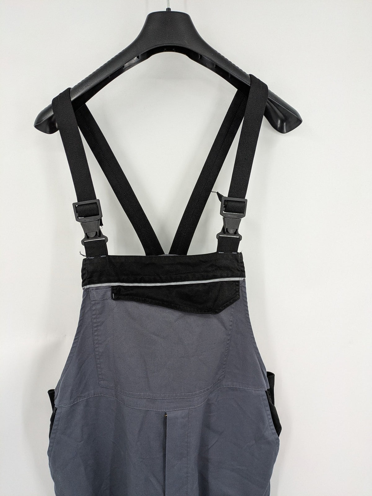Works Wear grey and black overalls with adjustable straps and multiple pockets.