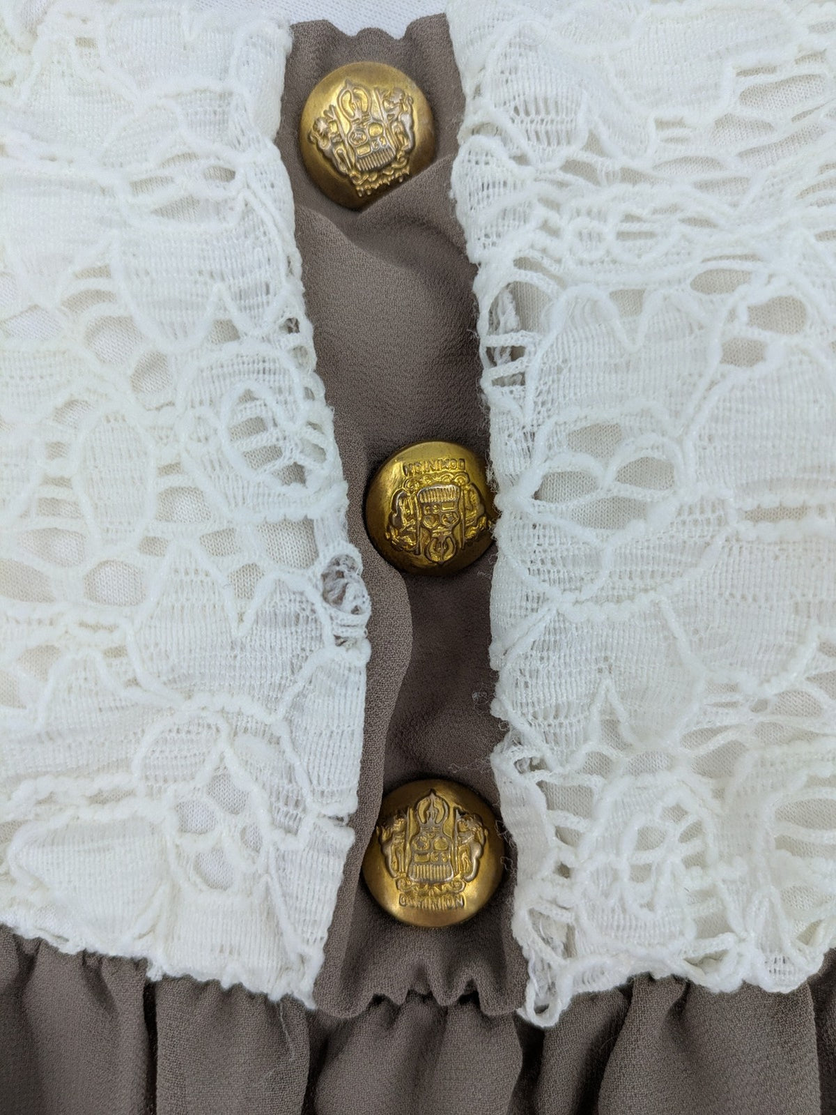 Creme bandeau summer dress in taupe with lace top and decorative gold buttons.