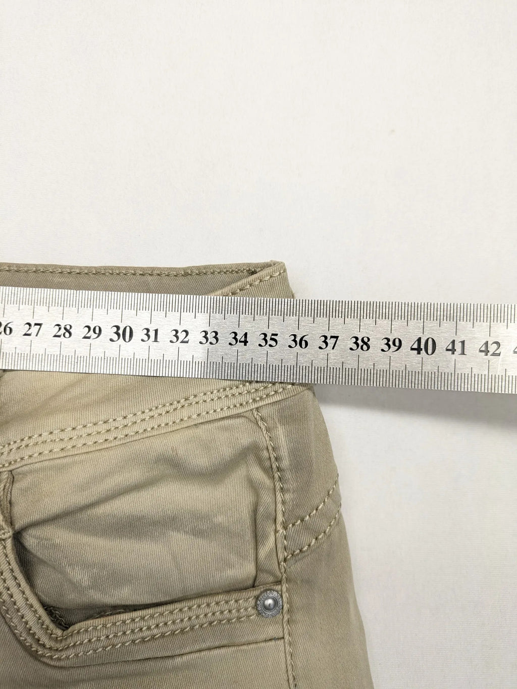 Mozaar beige straight jeans with unique asymmetrical button placket and practical pockets.