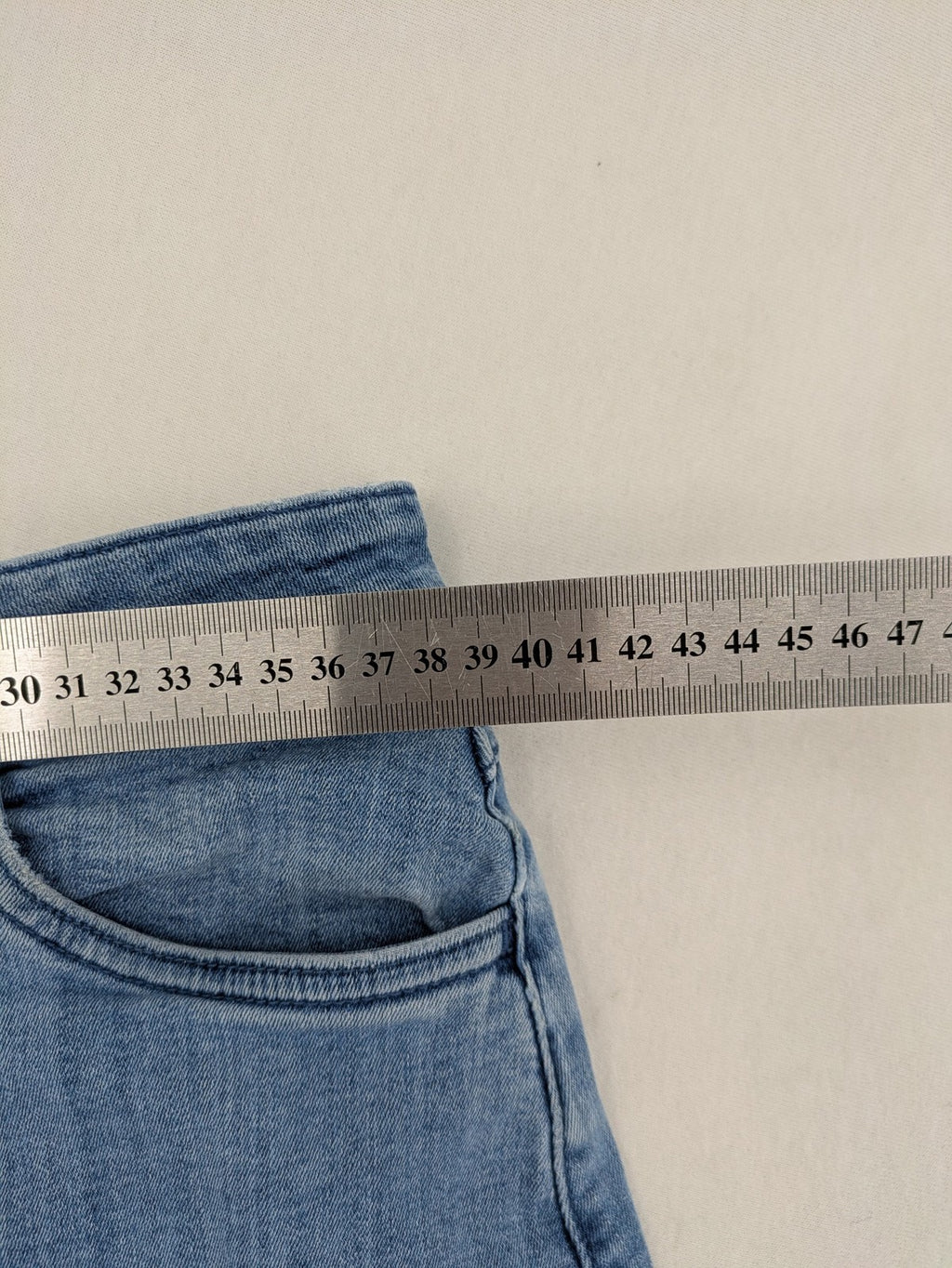 Tchibo blue A-line denim skirt classic five-pocket design with zipper and button closure.