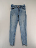 Clockhouse blue skinny jeans with distressed details and frayed hem, mid-rise fit.