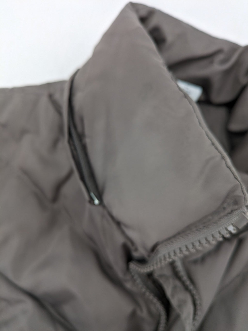 L&A Fashion grey puffer vest with zip closure, stand collar, and side pockets.