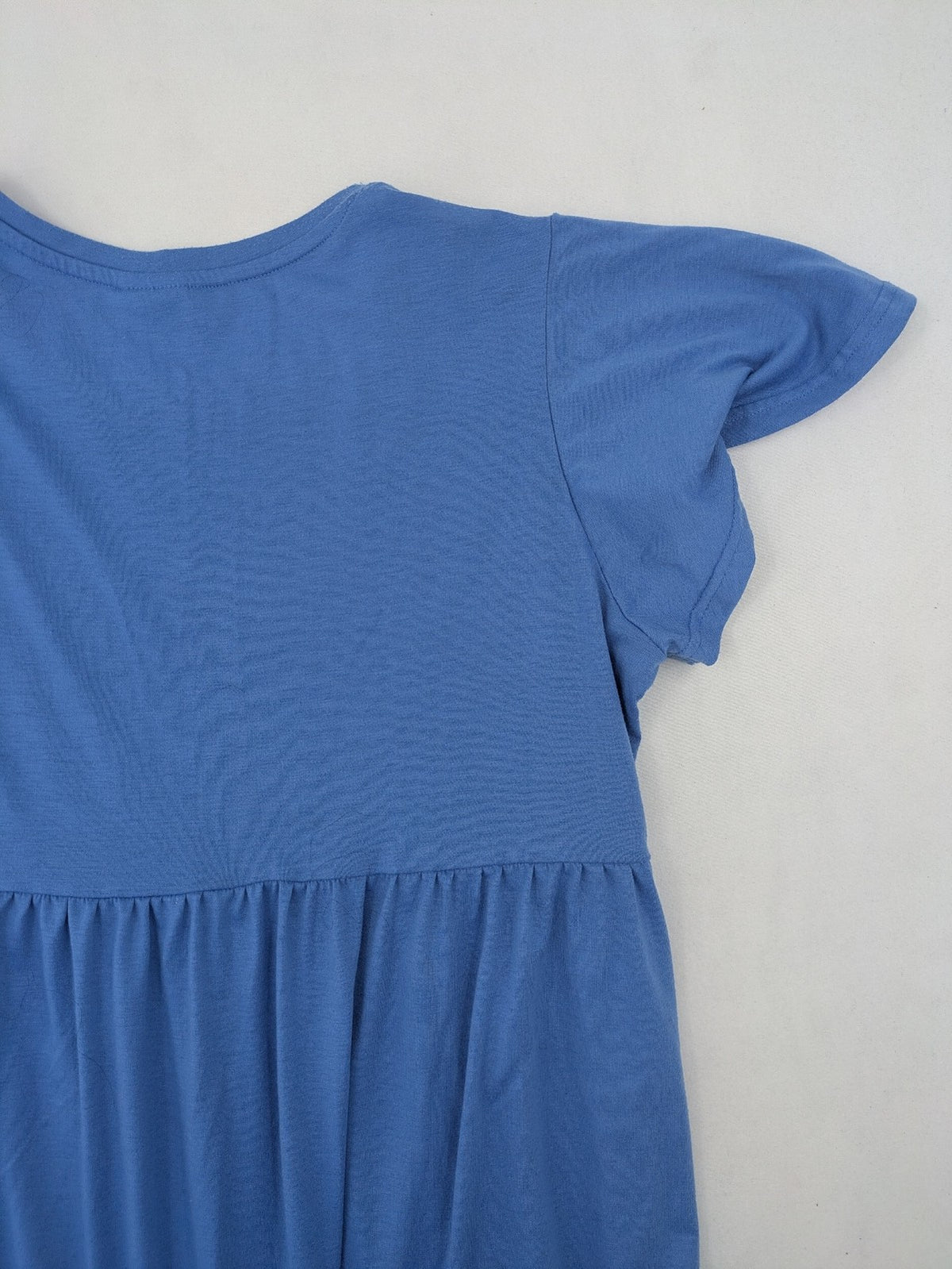 Infinity blue T-shirt dress A-line cut with playful flutter sleeves and soft stretch fabric.
