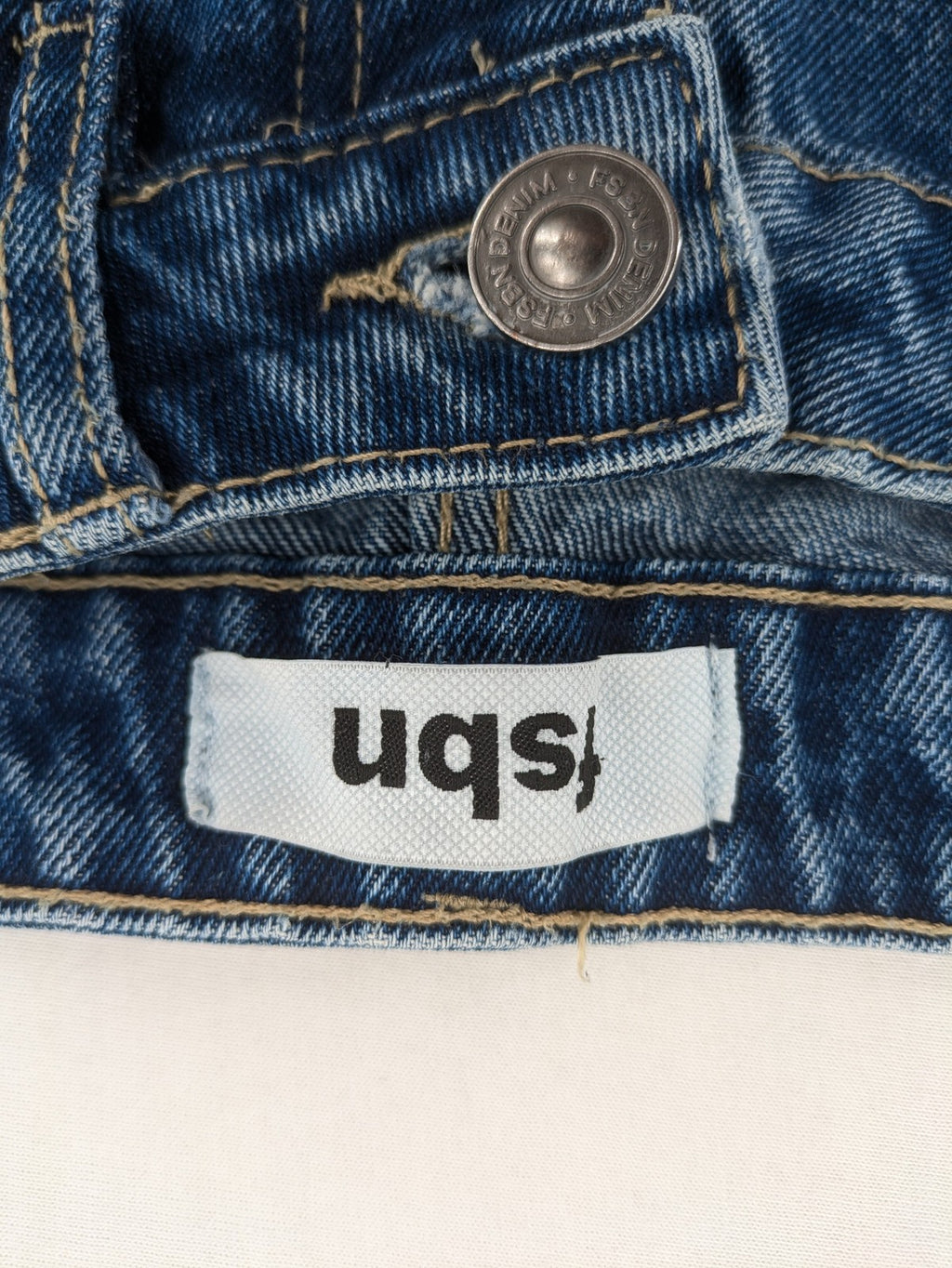 FSBN blue straight jeans with distressed knee rips and classic button fly.