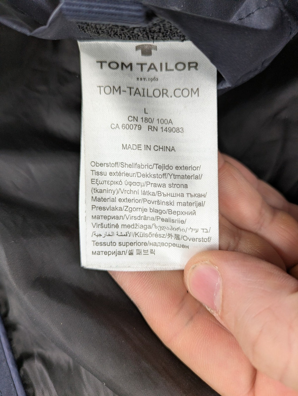 Tom Tailor navy puffer jacket with quilted design and adjustable hood, featuring multiple pockets.