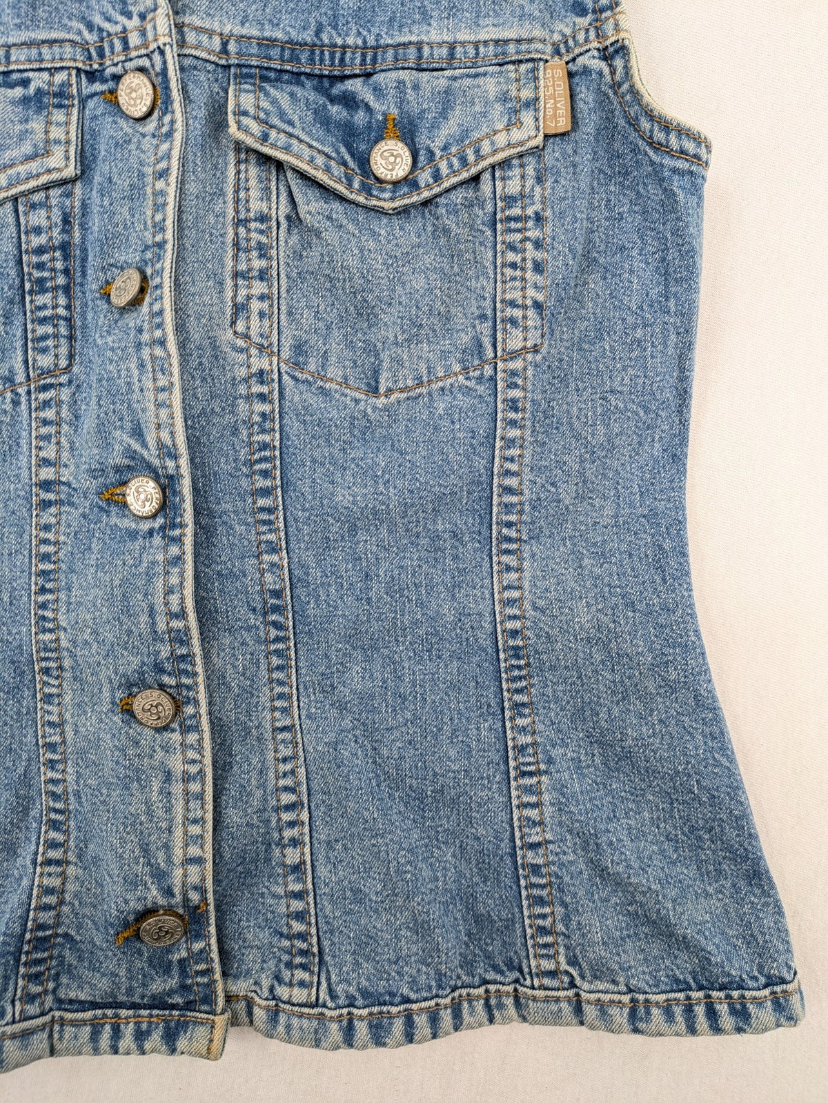 s.Oliver blue denim vest with button closure, pointed collar, and breast pockets.