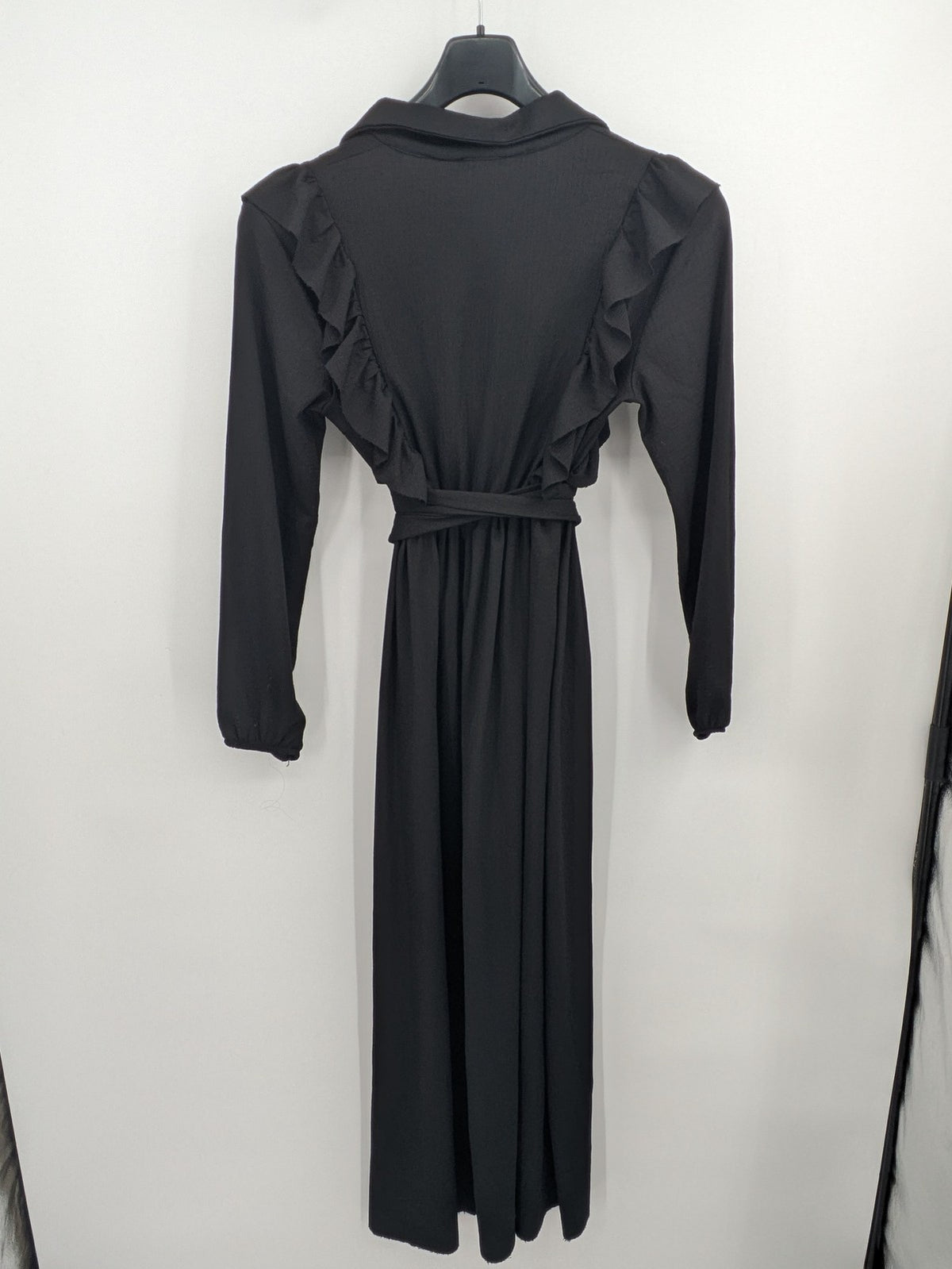 Hakke black maxi dress with ruffle details, long sleeves, and matching belt.