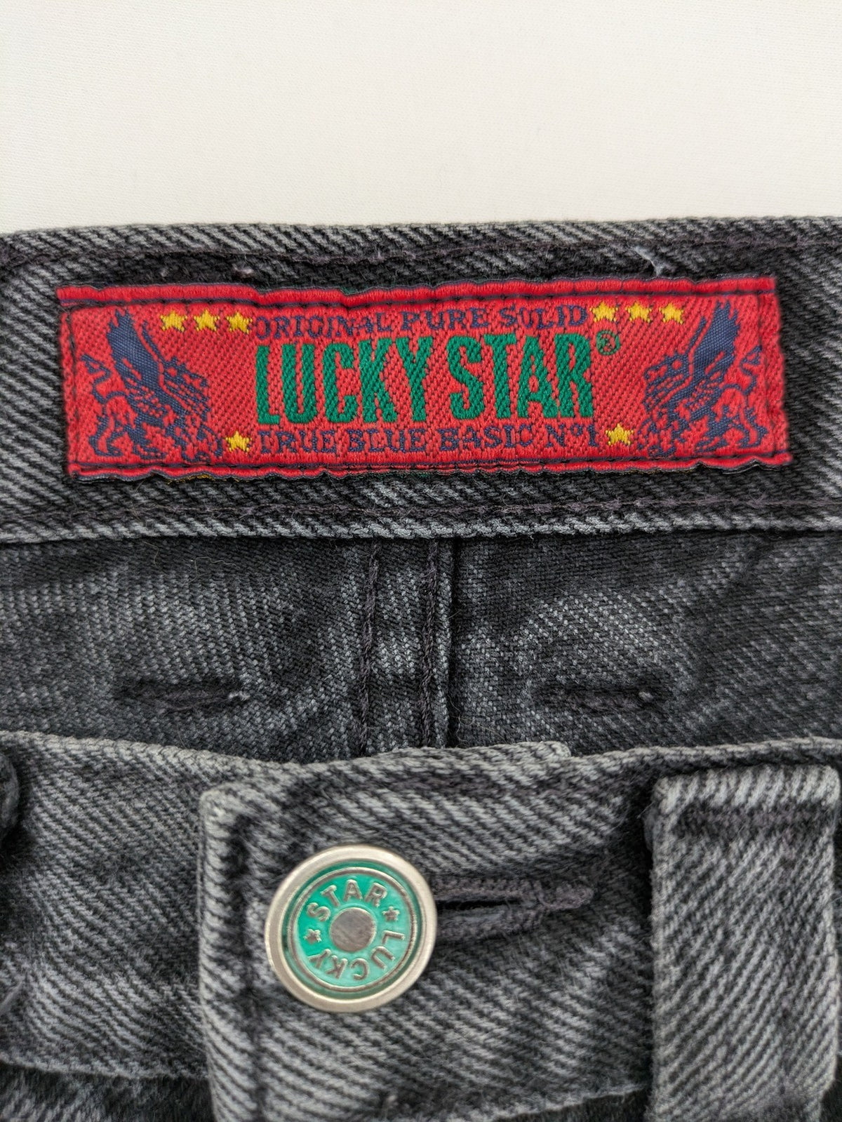 Lucky Star grey tapered high waist jeans with faded wash and red logo details.